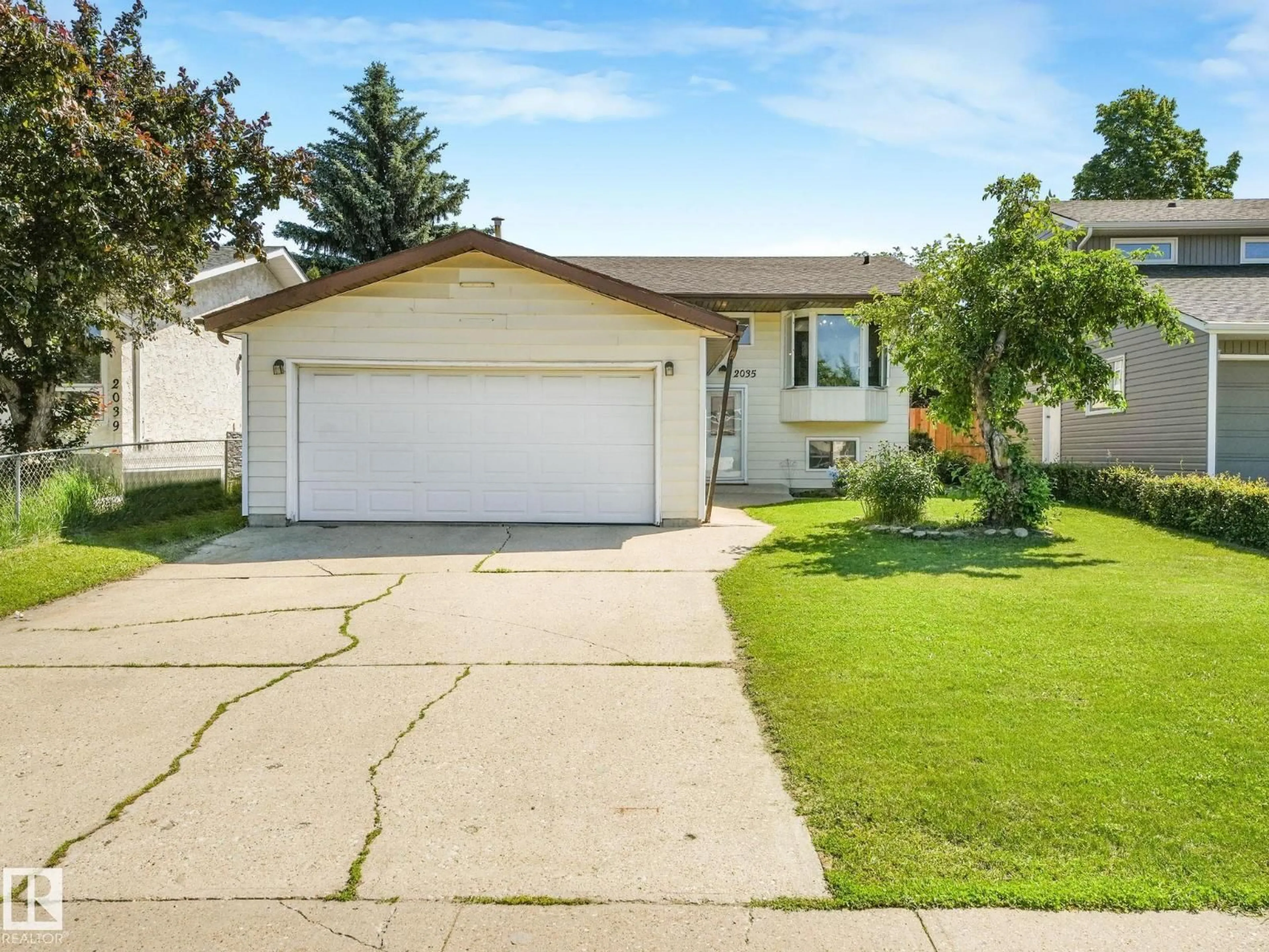 Home with vinyl exterior material, street for 2035 49A ST NW, Edmonton Alberta T6L2W9
