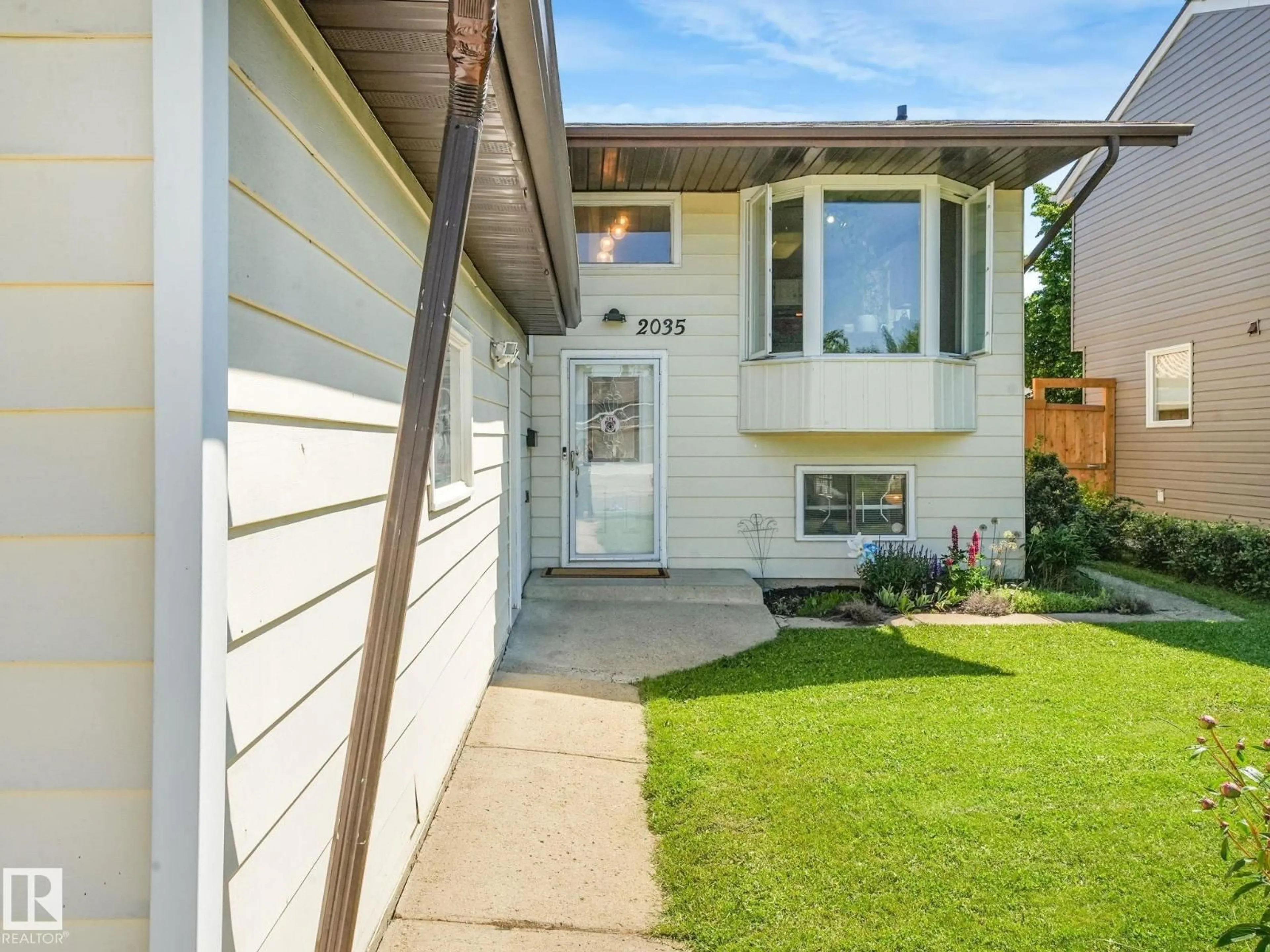 Home with vinyl exterior material, street for 2035 49A ST NW, Edmonton Alberta T6L2W9