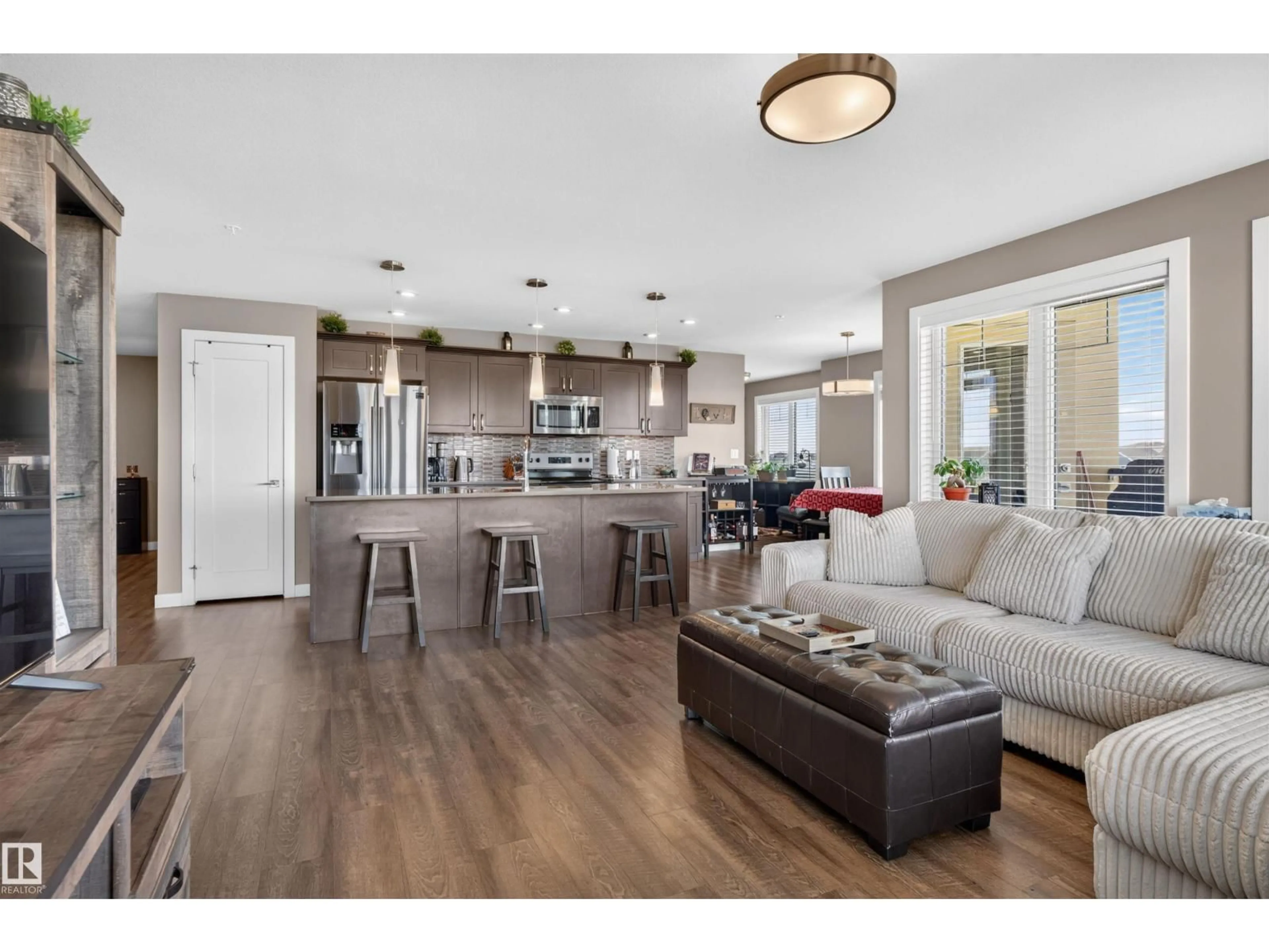 Open concept kitchen, wood/laminate floor for #307 - 1029 173 ST, Edmonton Alberta T6W3E4