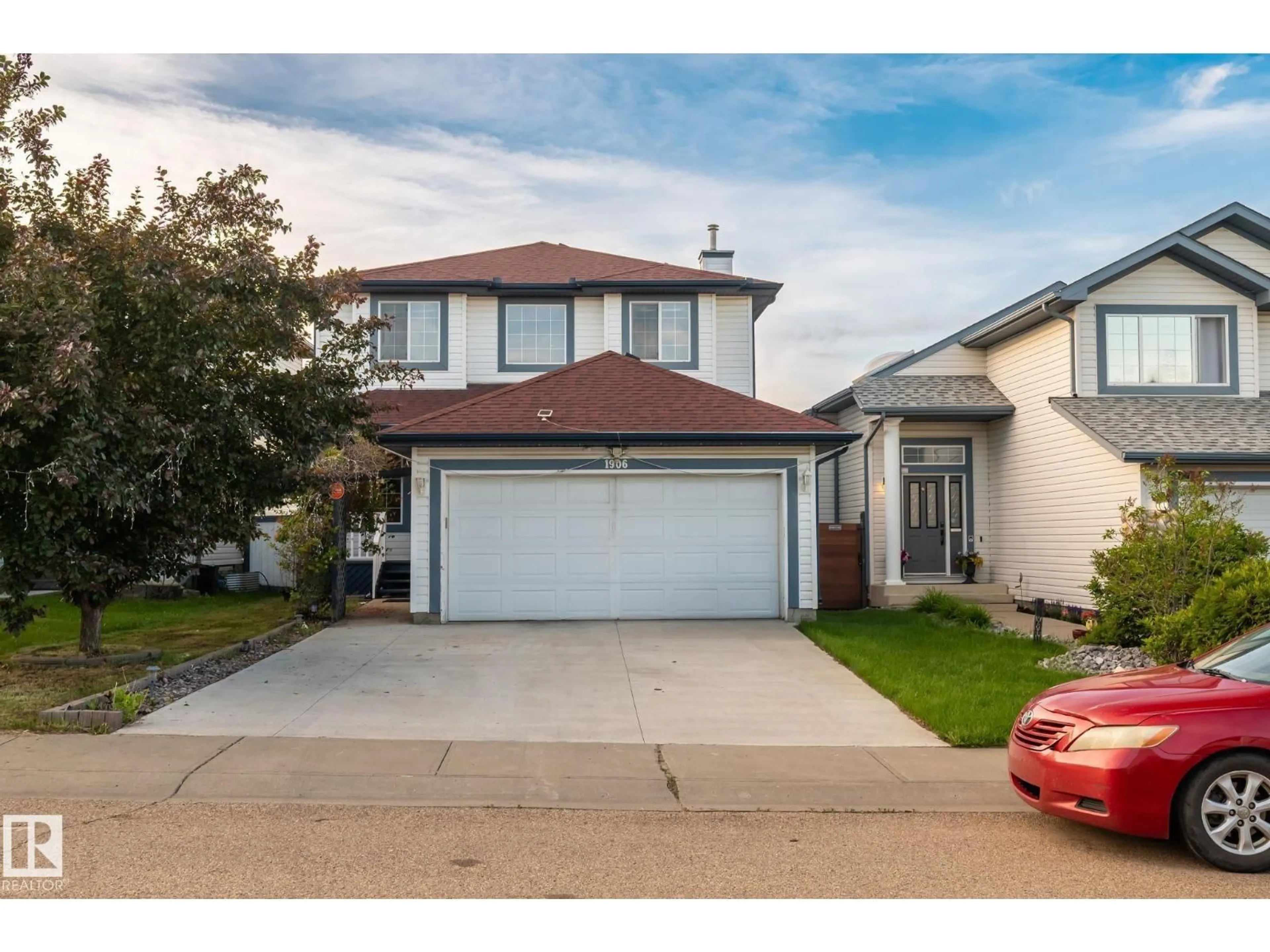 Home with vinyl exterior material, street for 1906 37B AV, Edmonton Alberta T6T1S5