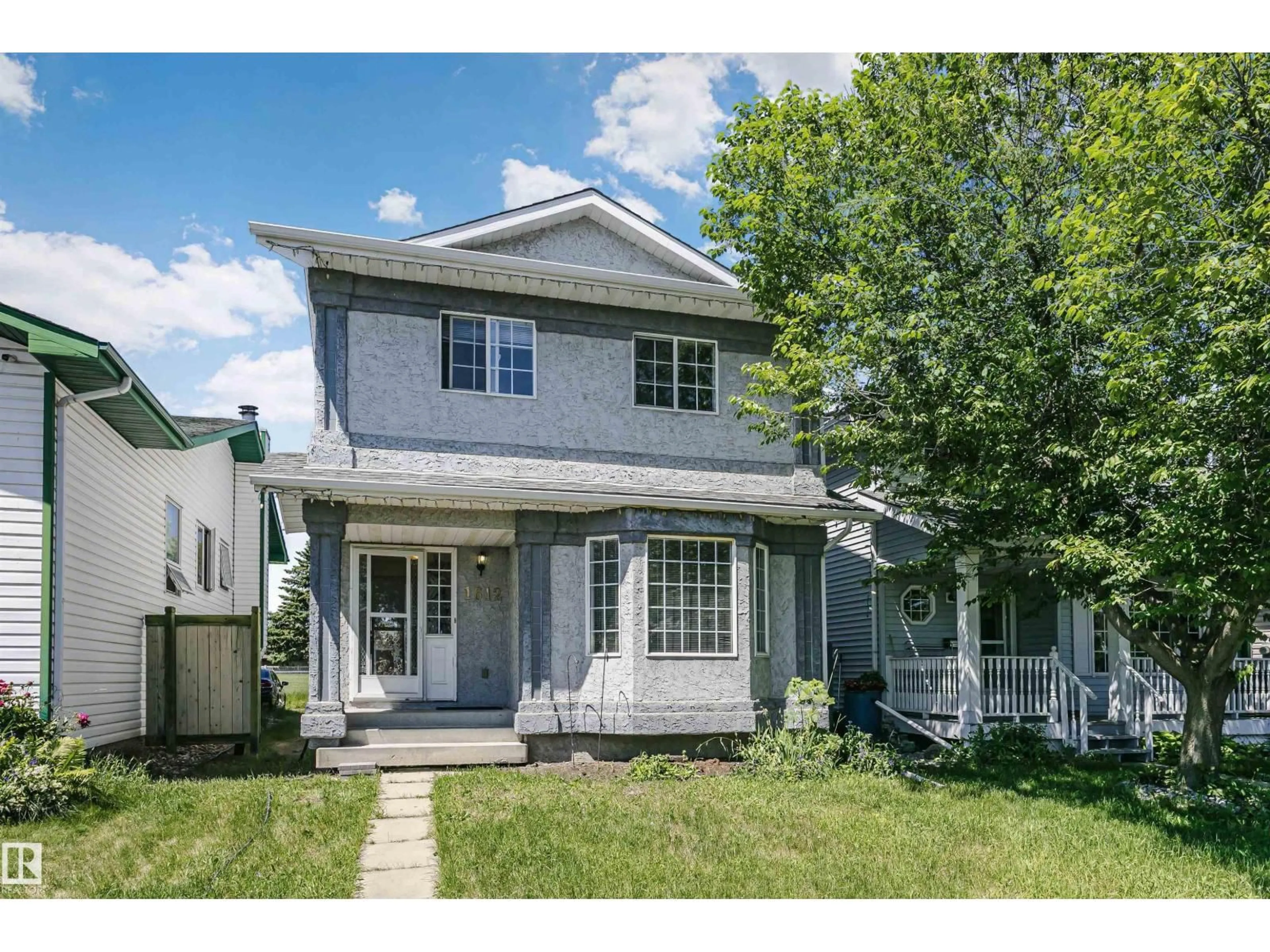 Home with vinyl exterior material, street for NW - 1612 80A ST, Edmonton Alberta T6K4E1