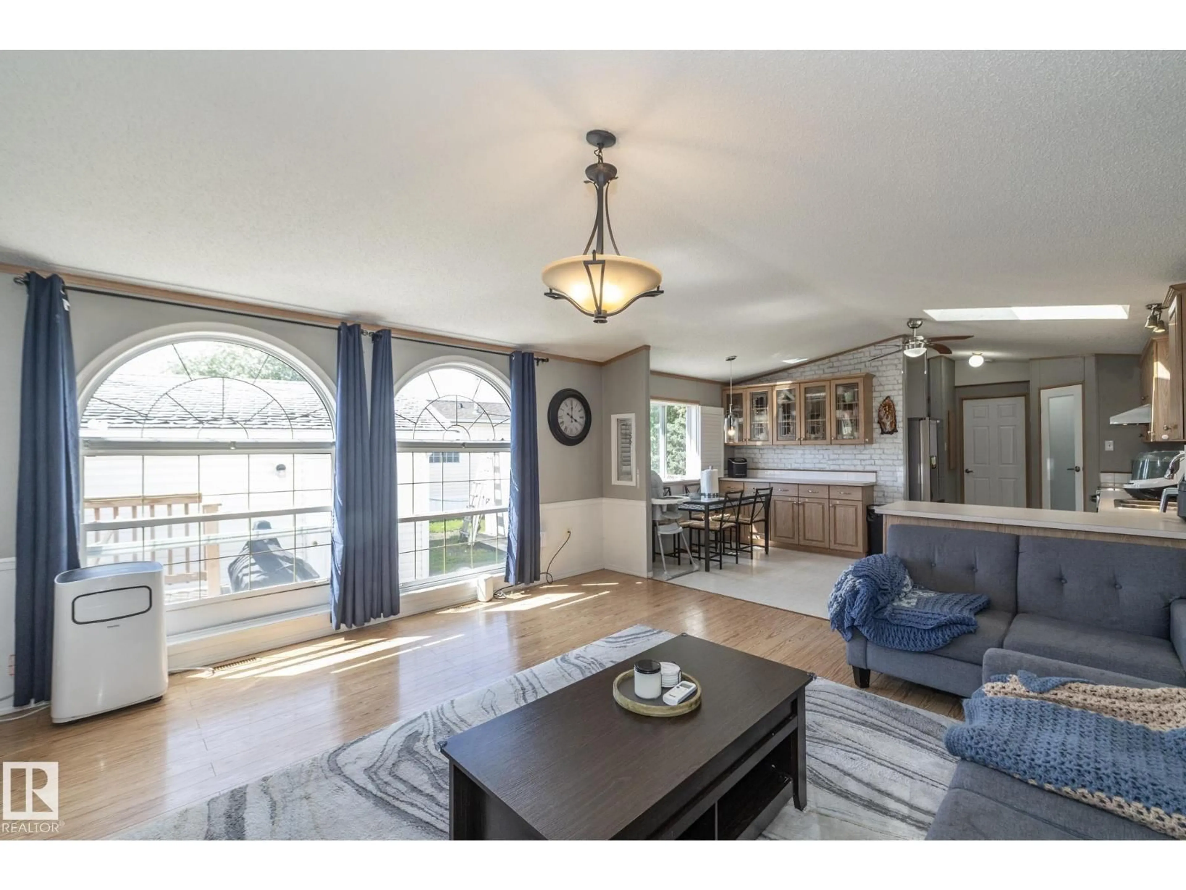 Living room with furniture, wood/laminate floor for W - 143 48 3400 ST, Stony Plain Alberta T7Z1V9
