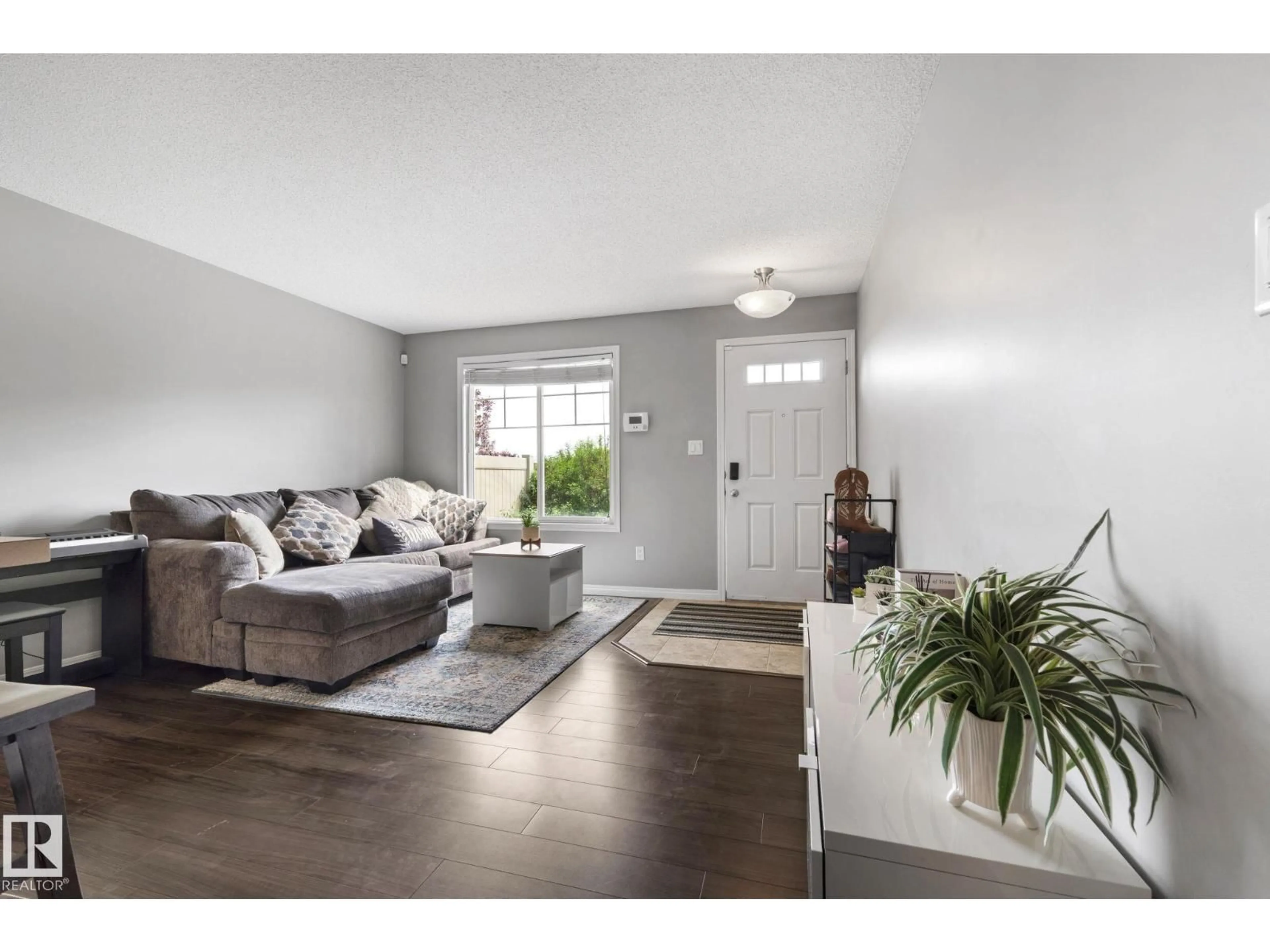 Living room with furniture, wood/laminate floor for #8 - 1030 CHAPPELLE BV, Edmonton Alberta T6W2K7