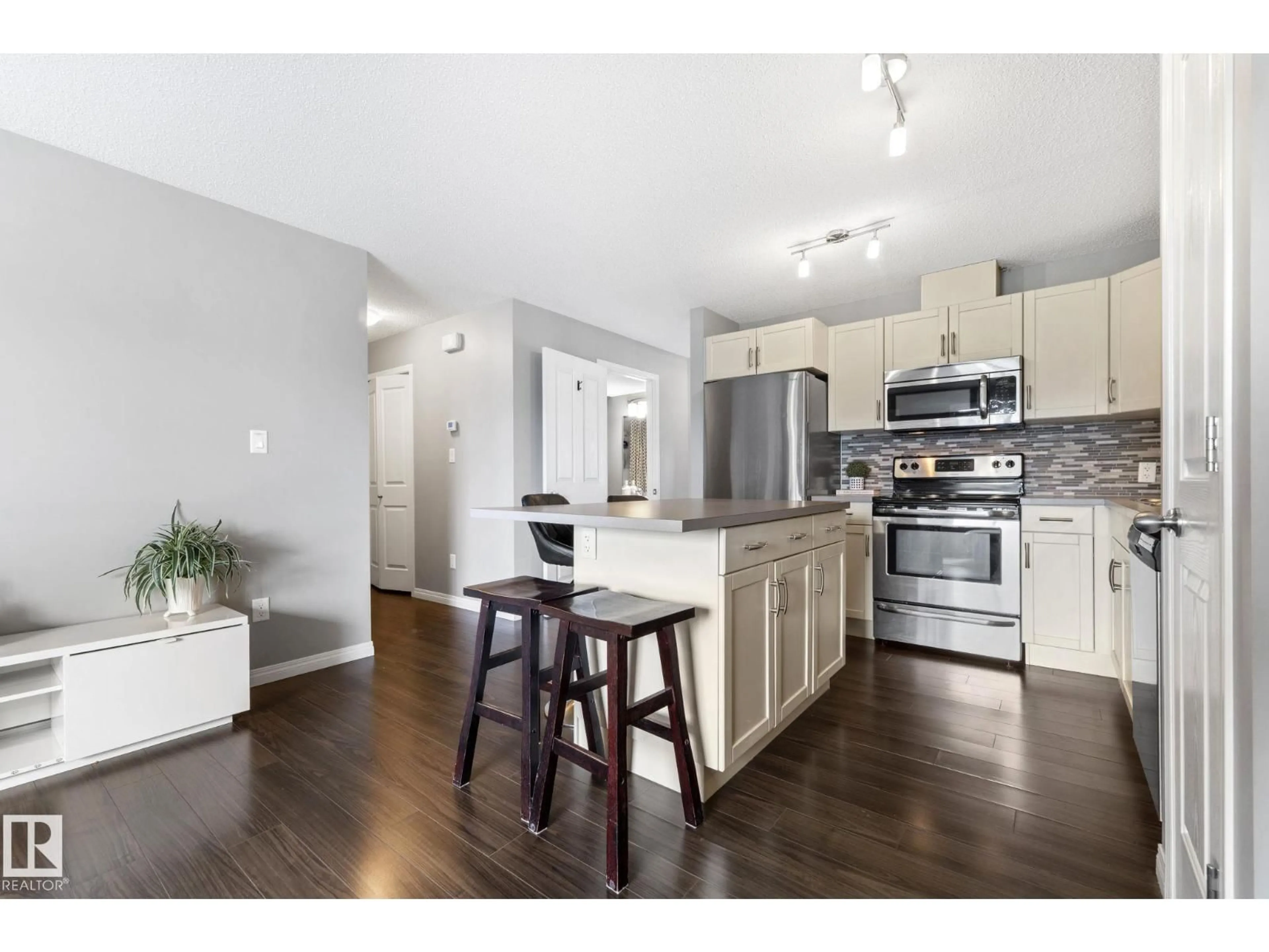 Open concept kitchen, wood/laminate floor for #8 - 1030 CHAPPELLE BV, Edmonton Alberta T6W2K7