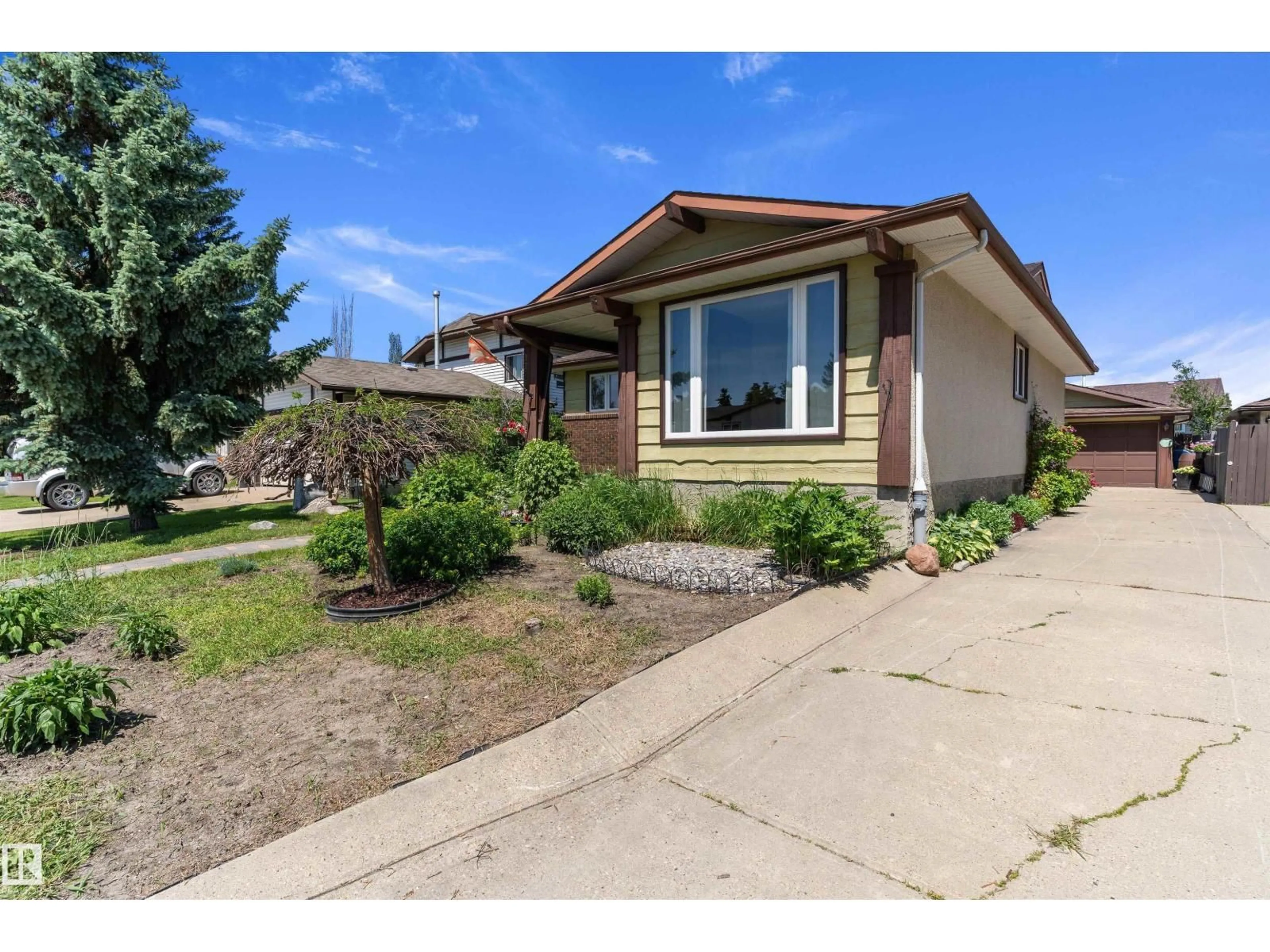 Home with vinyl exterior material, street for 12256 144 AV, Edmonton Alberta T5X3M4