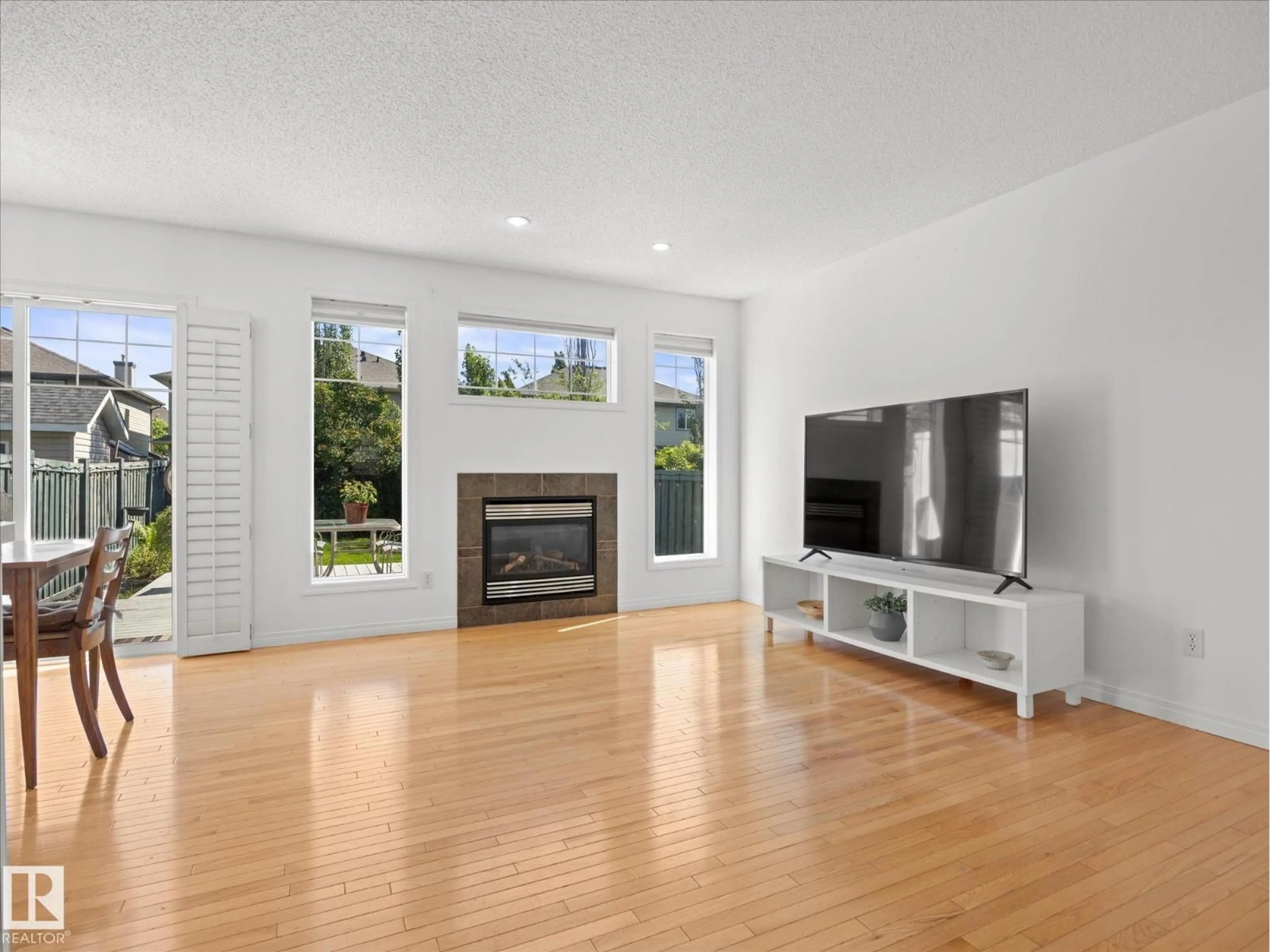 Living room with furniture, wood/laminate floor for SW - 12126 16 AV, Edmonton Alberta T6W1L9