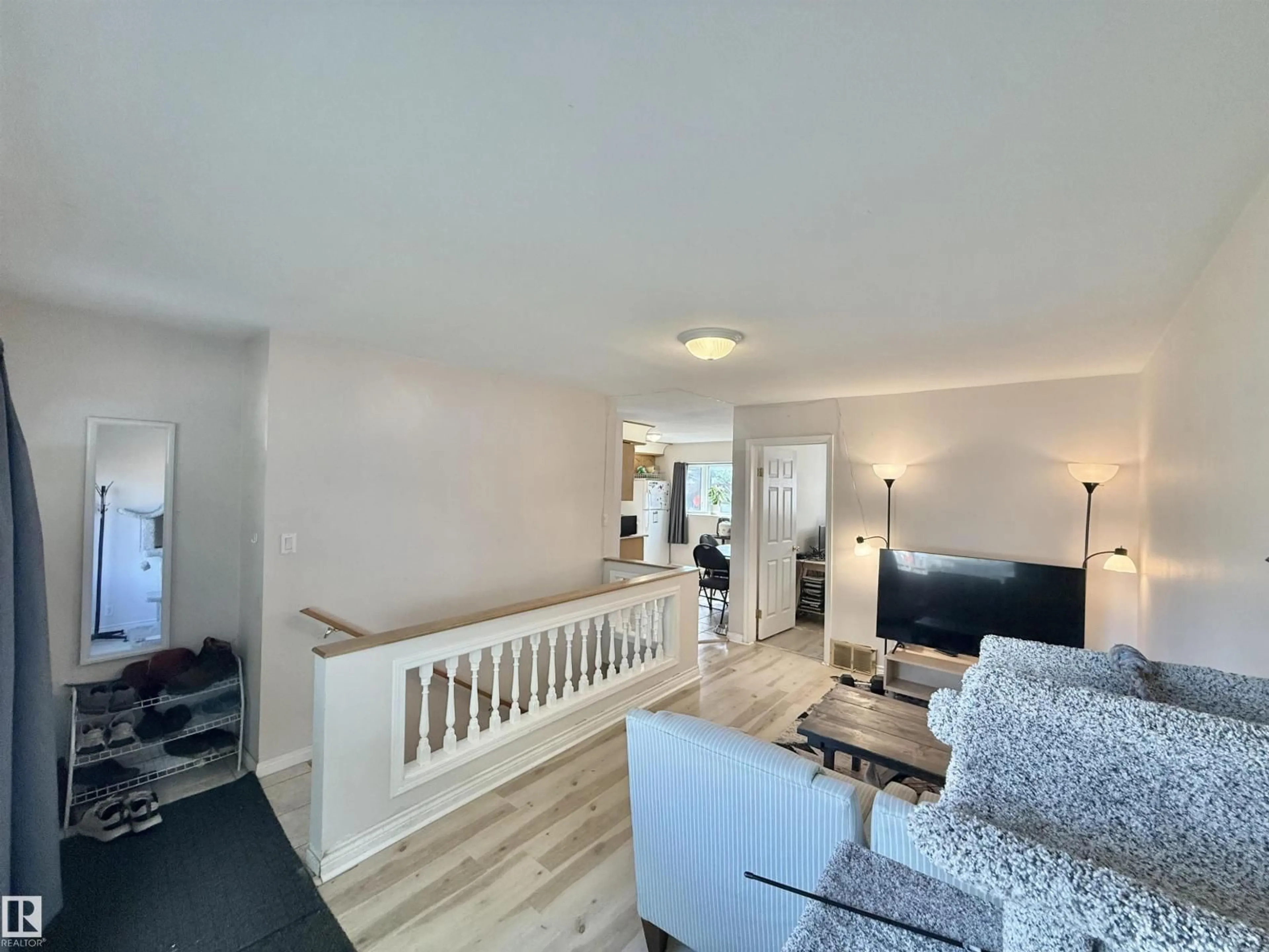 Living room with furniture, wood/laminate floor for NW - 11941 78 ST, Edmonton Alberta T5B1J6