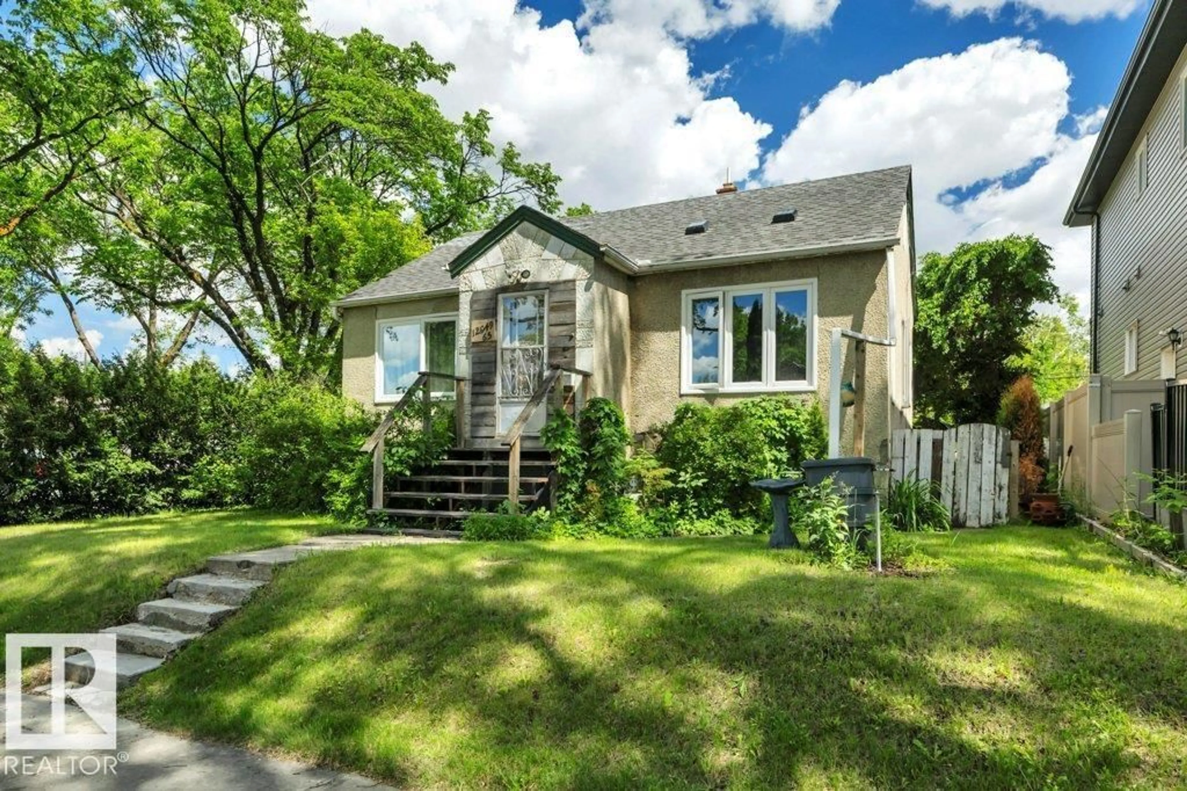 Home with vinyl exterior material, street for 12049 65 ST, Edmonton Alberta T5H2X6