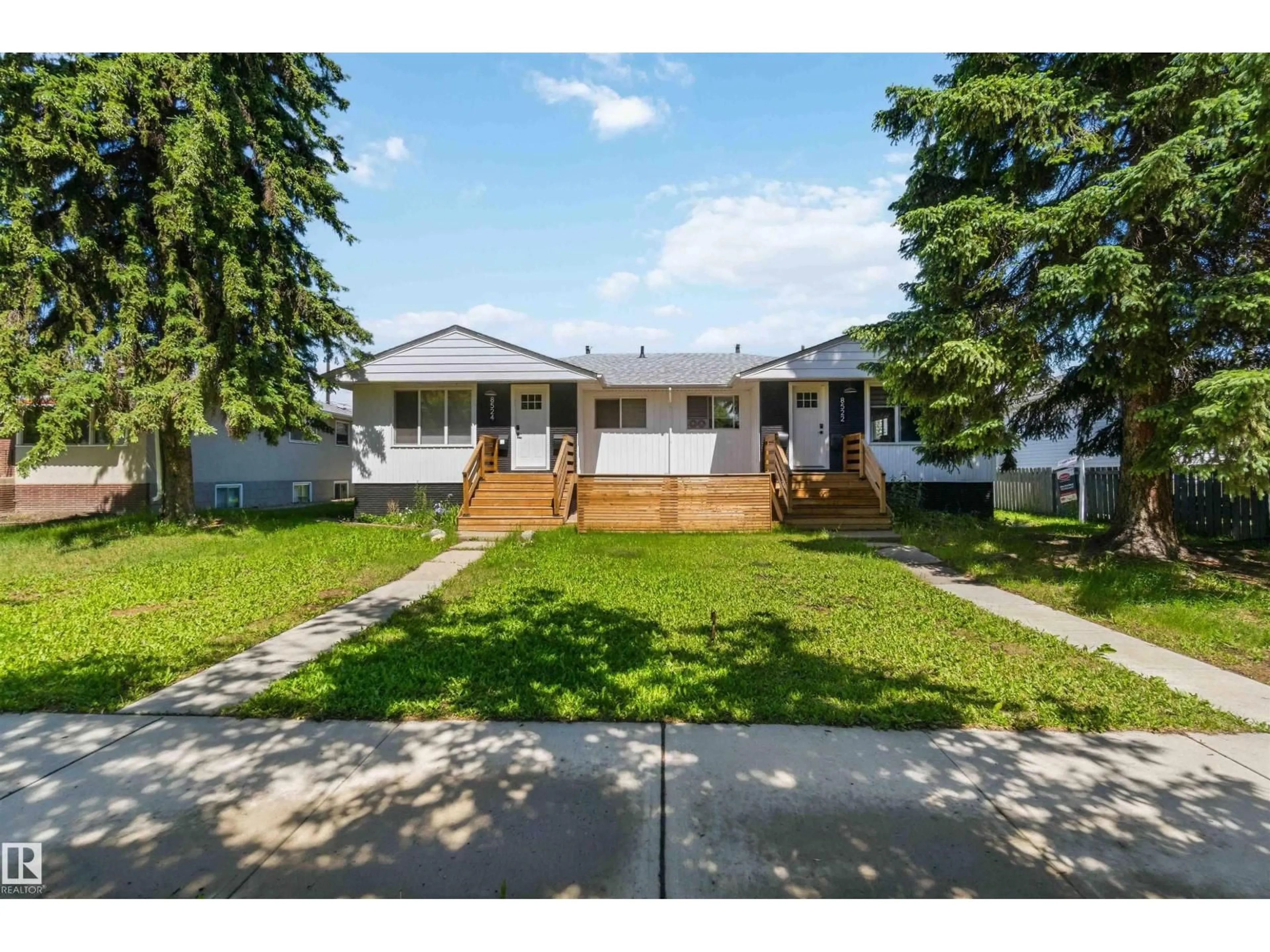 Home with vinyl exterior material, street for NW - 8522 8524 84 AV, Edmonton Alberta T6C1C9