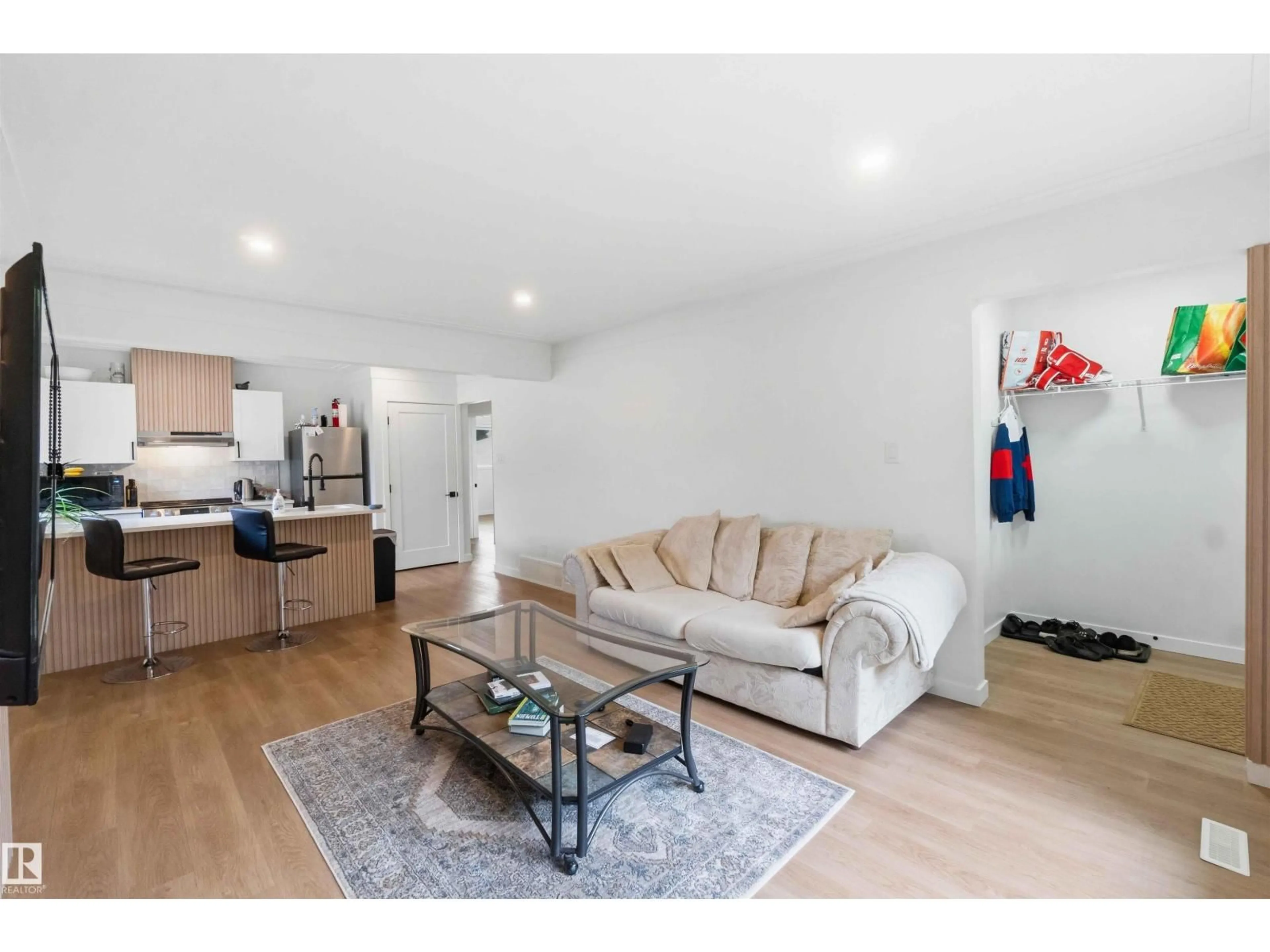 Living room with furniture, wood/laminate floor for NW - 8522 8524 84 AV, Edmonton Alberta T6C1C9