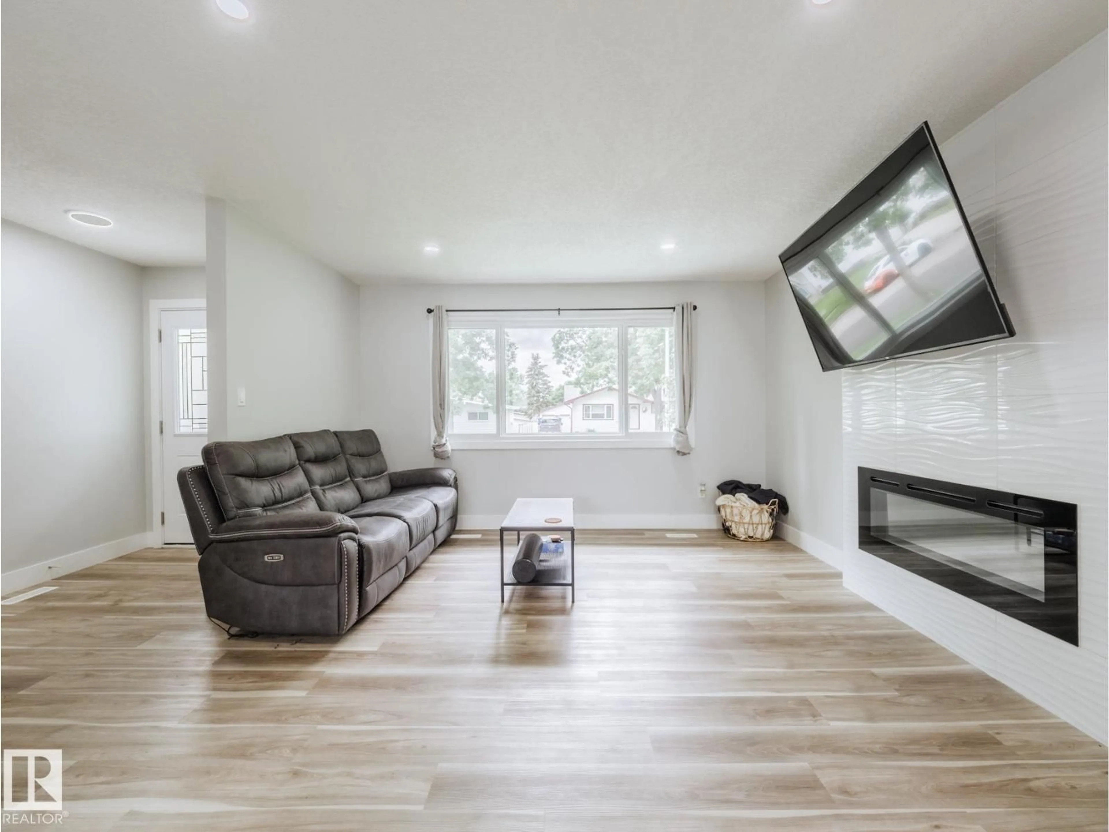 Living room with furniture, wood/laminate floor for 15011 59 ST, Edmonton Alberta T5A1Y6
