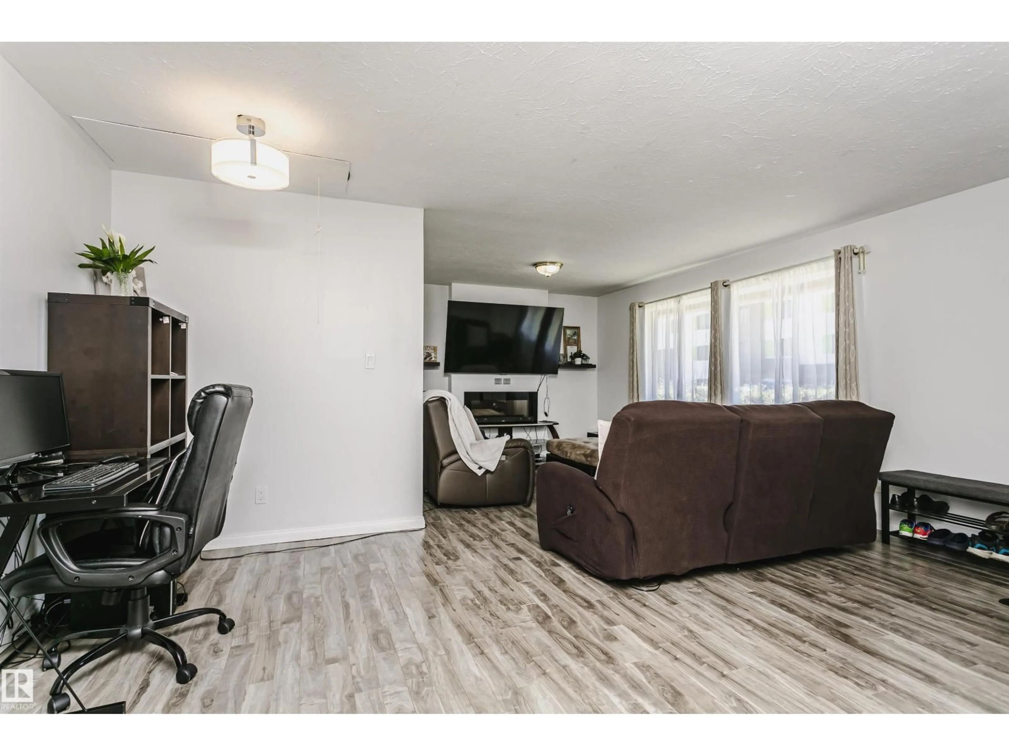 Living room with furniture, wood/laminate floor for 13104 128 AV, Edmonton Alberta T5L3H2