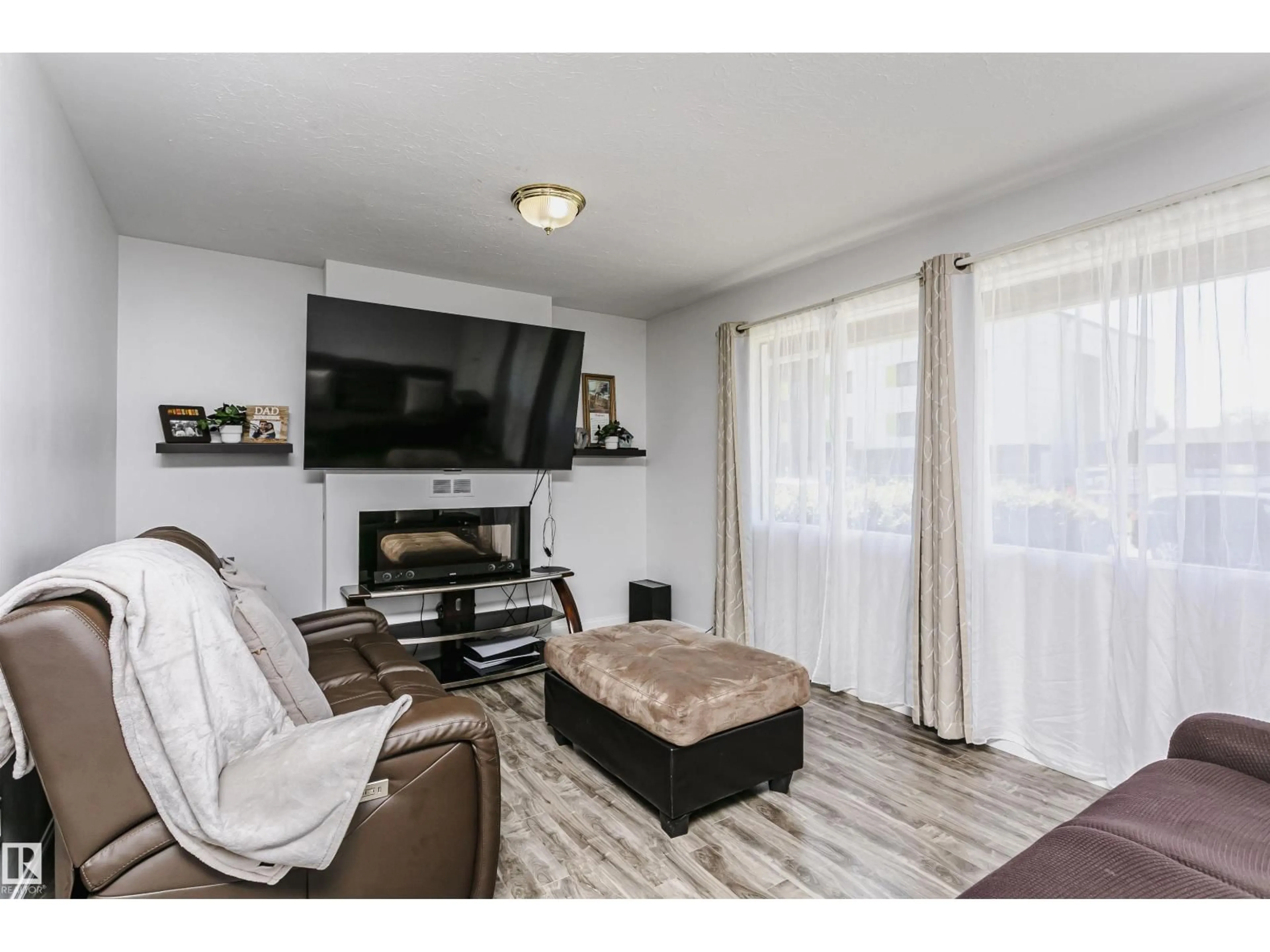 Living room with furniture, wood/laminate floor for 13104 128 AV, Edmonton Alberta T5L3H2