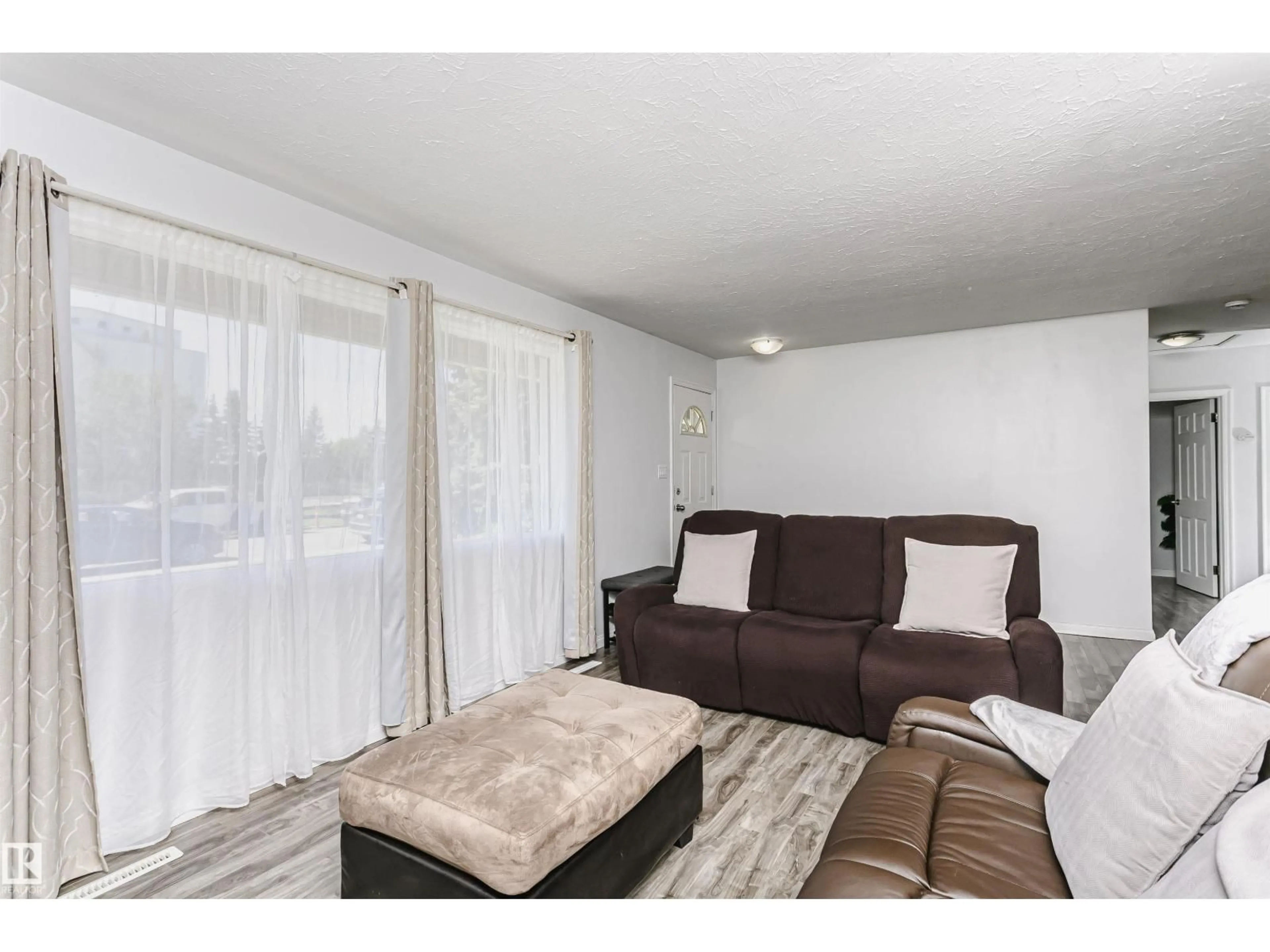 Living room with furniture, wood/laminate floor for 13104 128 AV, Edmonton Alberta T5L3H2