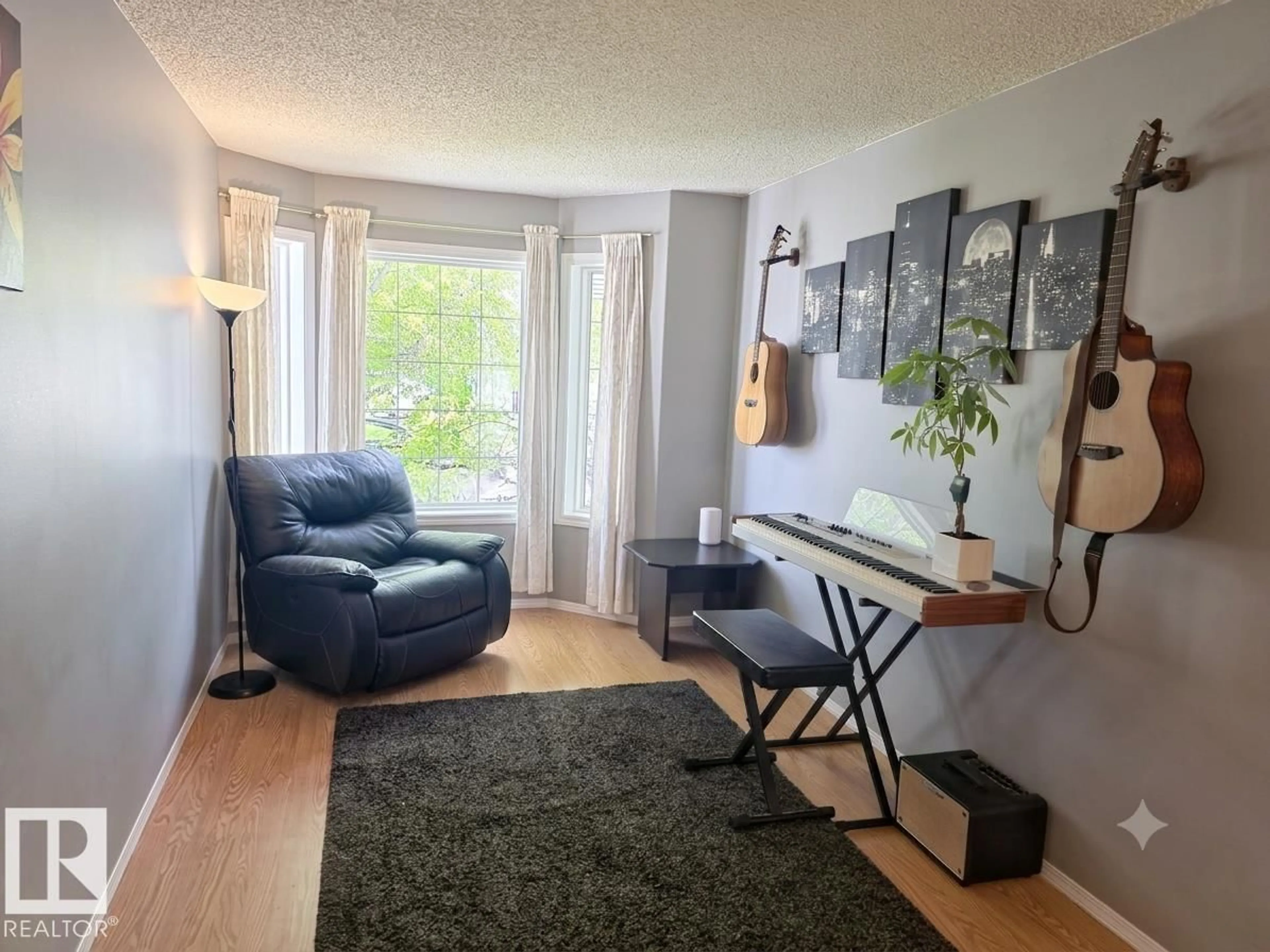 Living room with furniture, wood/laminate floor for 12237 140A AV, Edmonton Alberta T5X6E6