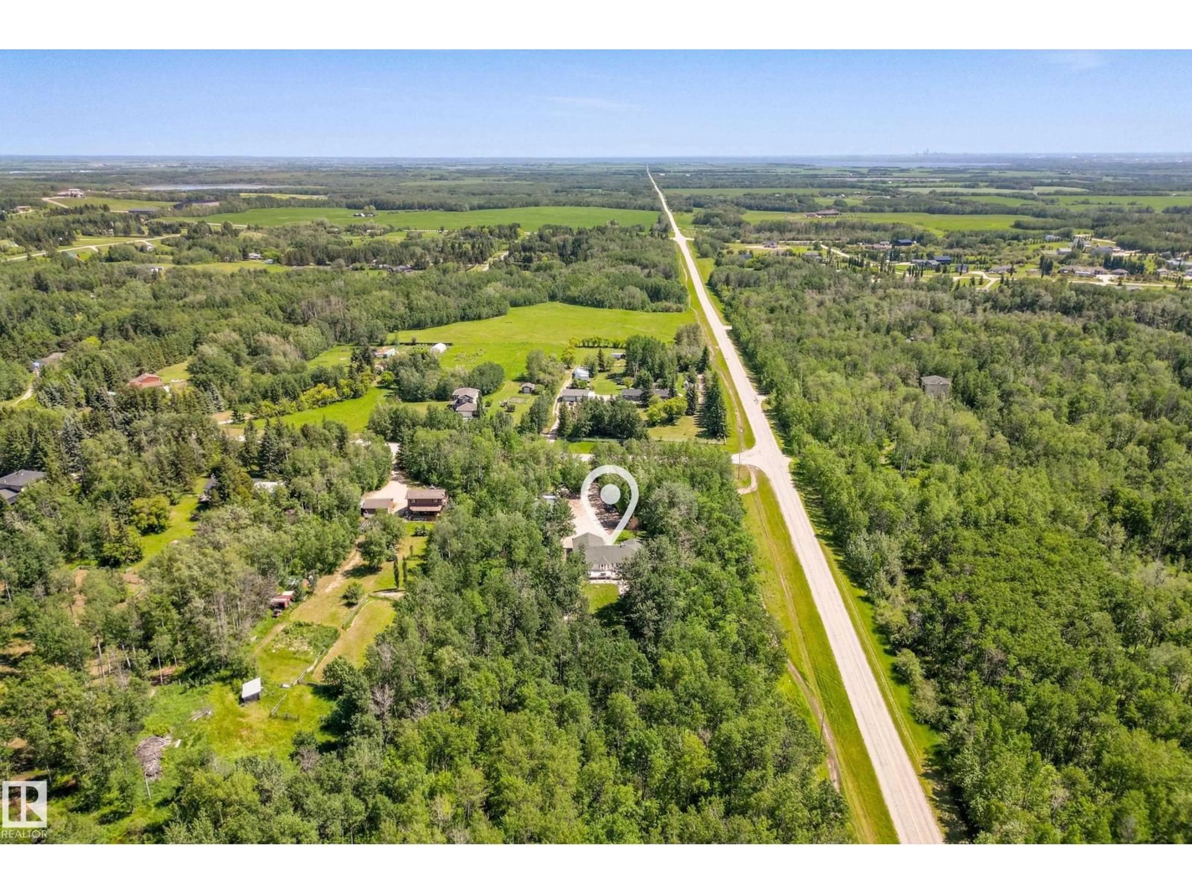 A pic from outside/outdoor area/front of a property/back of a property/a pic from drone, forest/trees view for #2 - 27420 TWP ROAD 540, Rural Parkland County Alberta T7X3S7