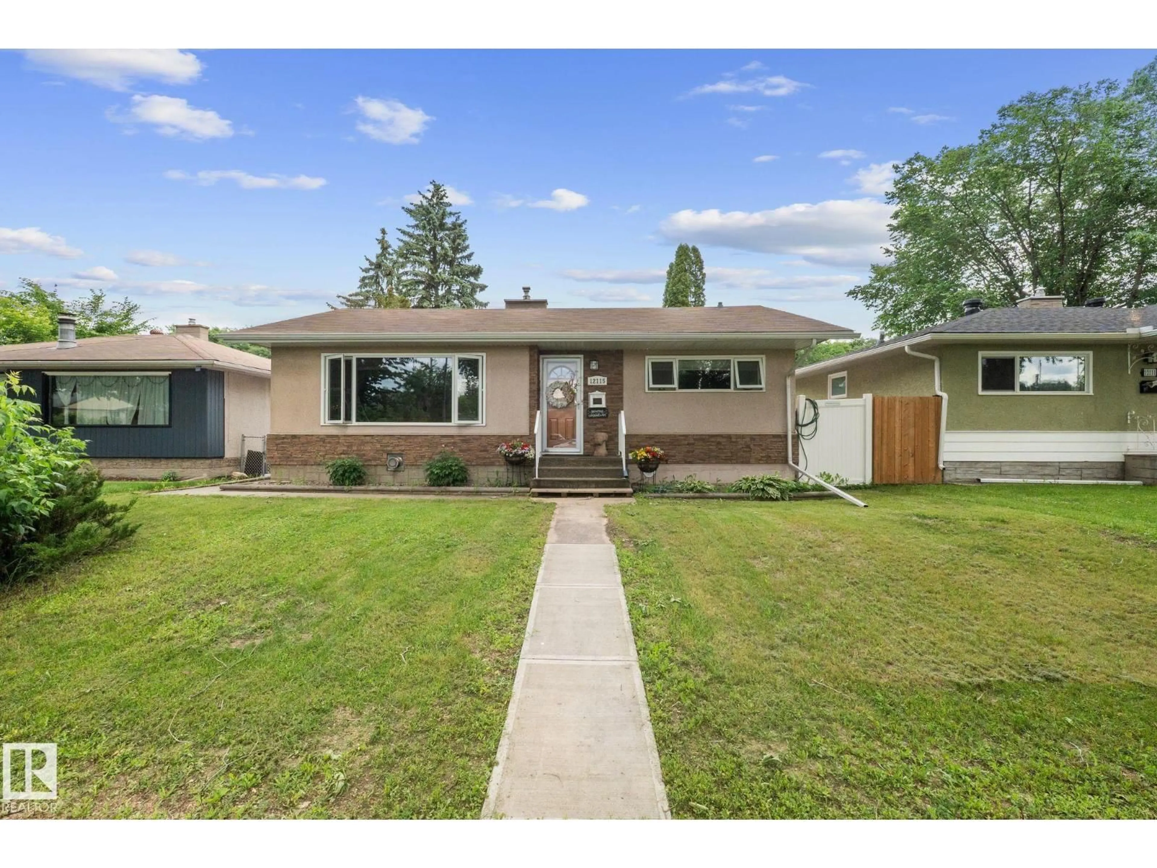 Home with vinyl exterior material, street for NW - 12115 53 ST, Edmonton Alberta T5W3L8