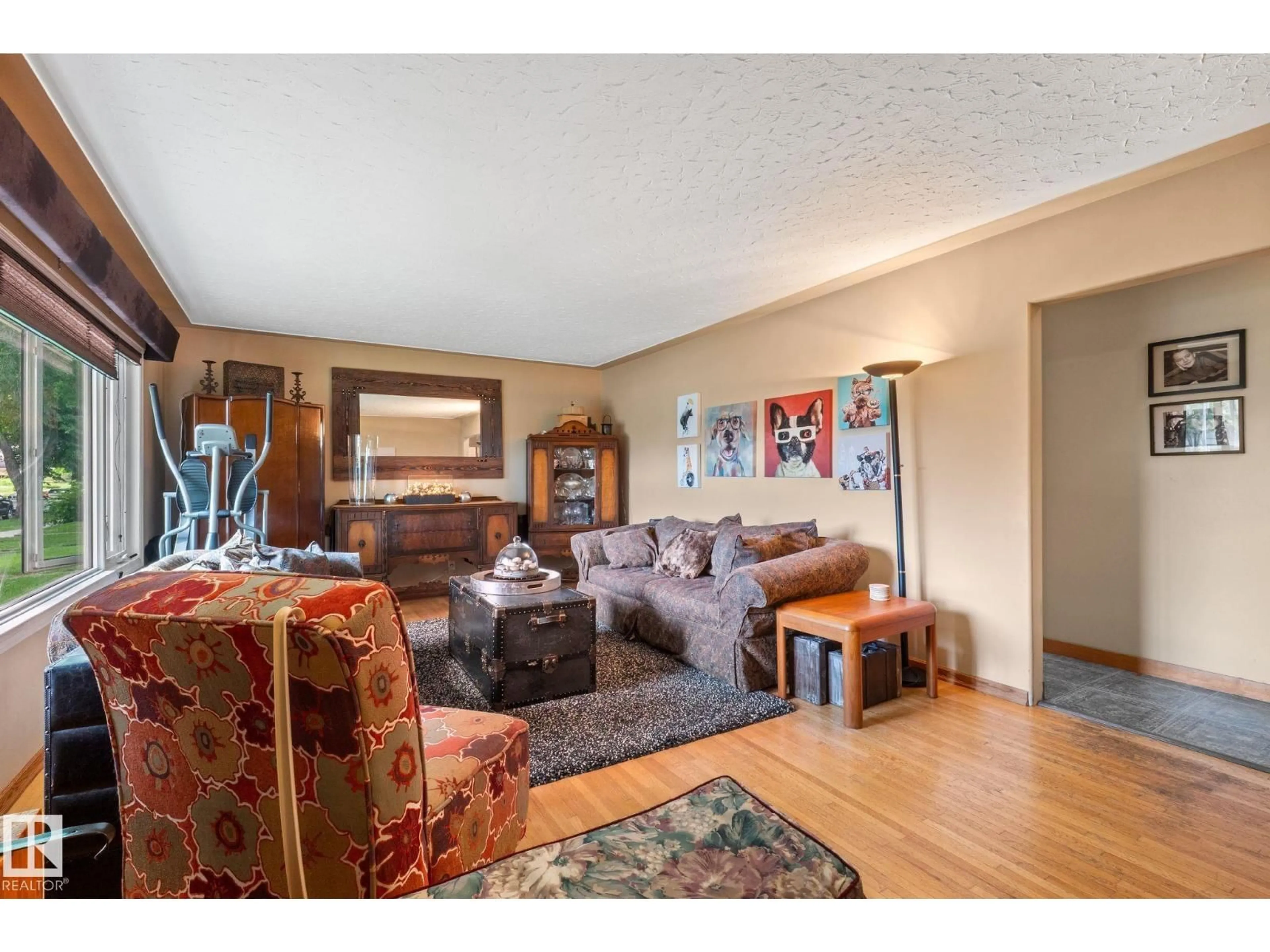 Living room with furniture, wood/laminate floor for NW - 12115 53 ST, Edmonton Alberta T5W3L8