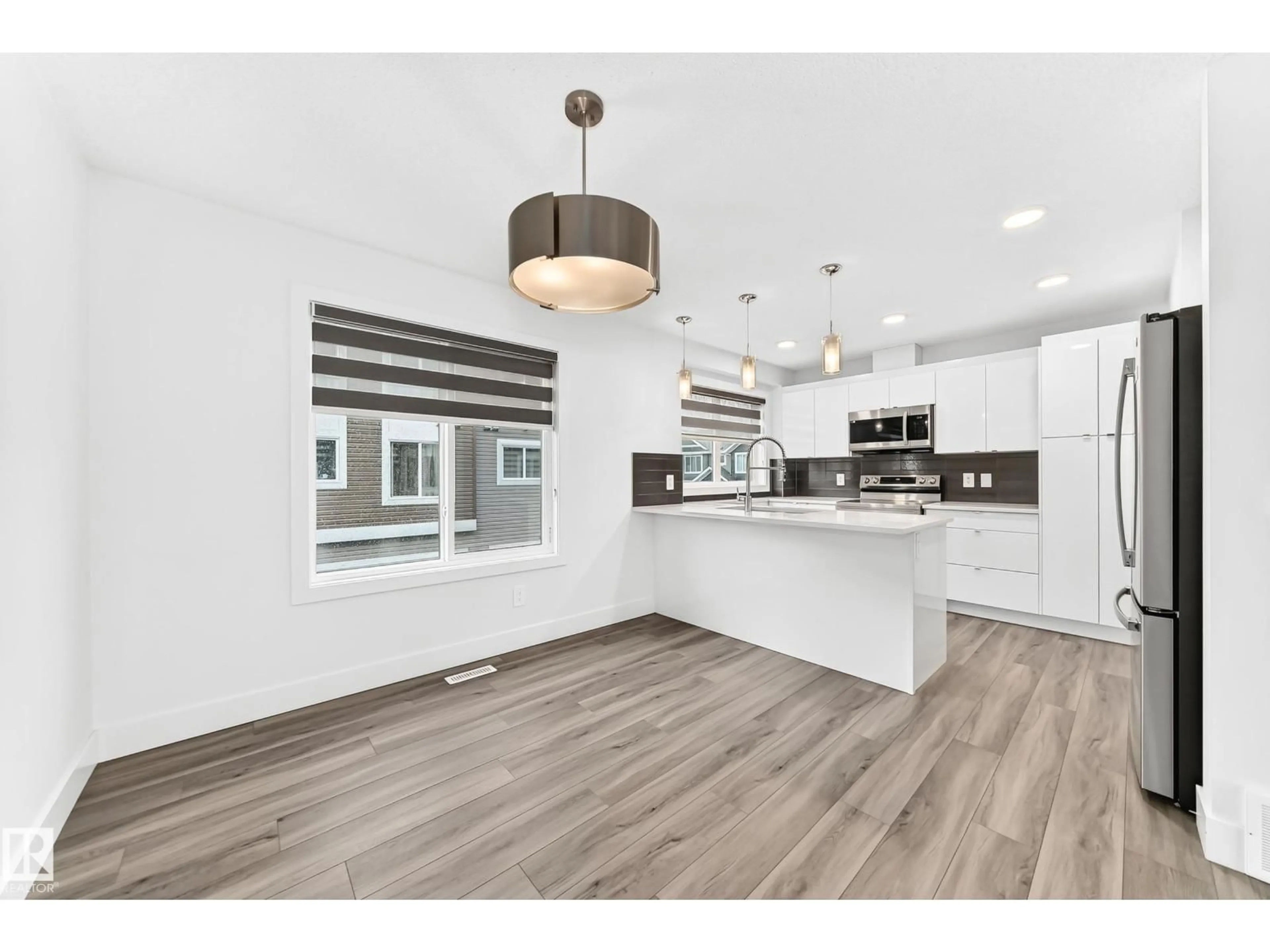 Open concept kitchen, wood/laminate floor for 17 - 4137 76 ST, Edmonton Alberta T6K1K8