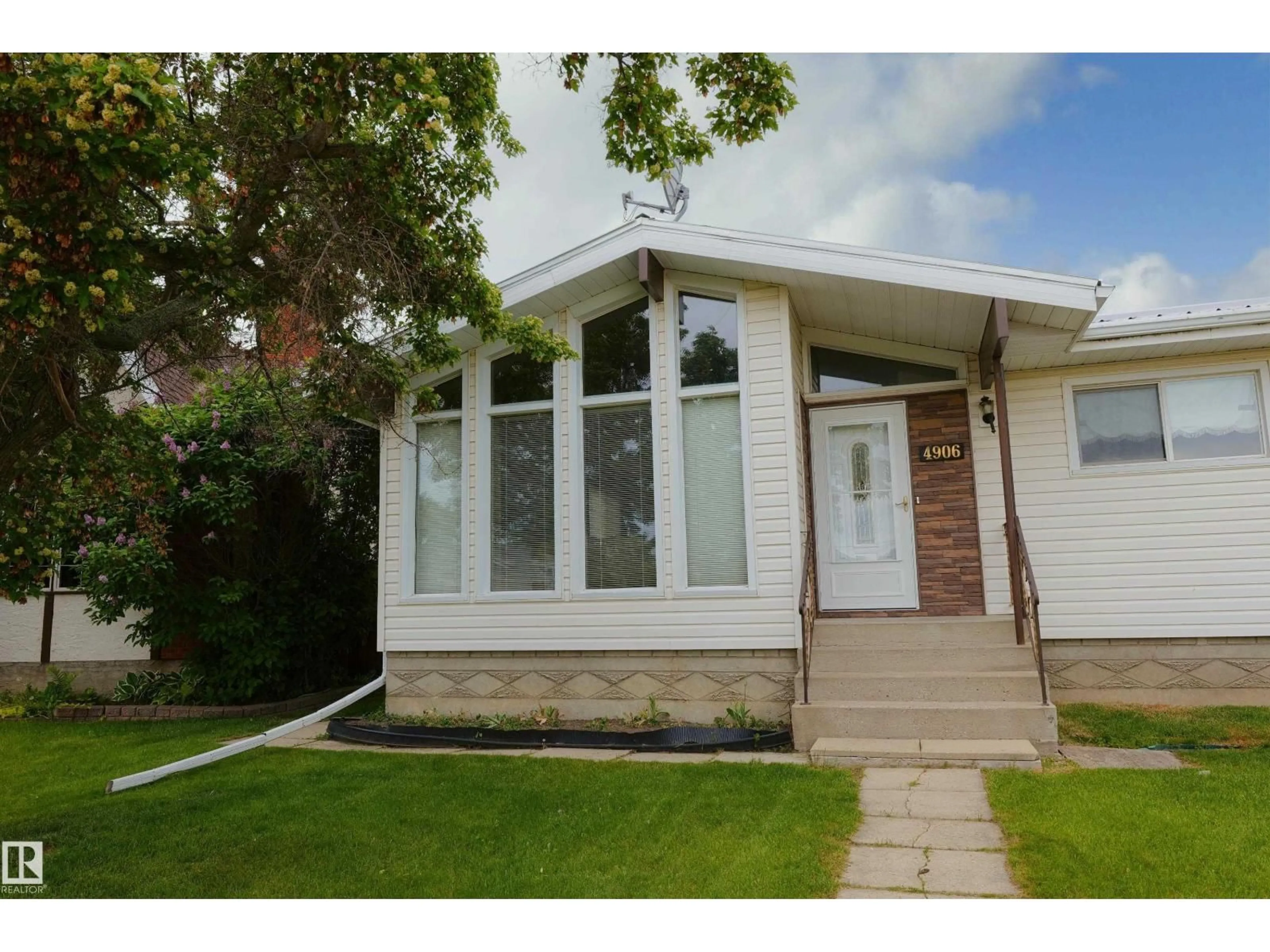 Home with vinyl exterior material, street for 4906 43A ST, Barrhead Alberta T0G0E0