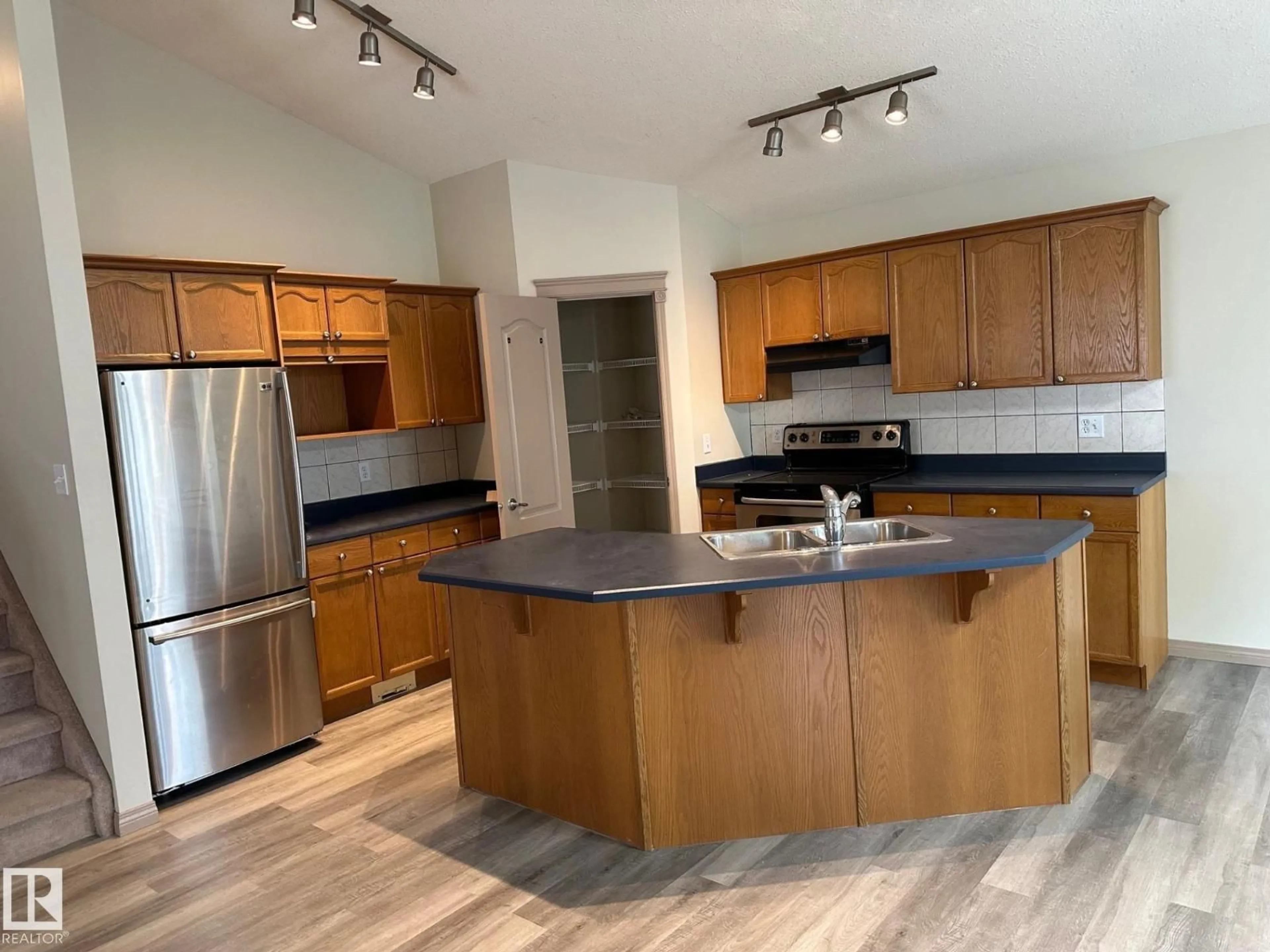 Open concept kitchen, wood/laminate floor for 1978 TOMLINSON GREEN GR, Edmonton Alberta T6R2R6