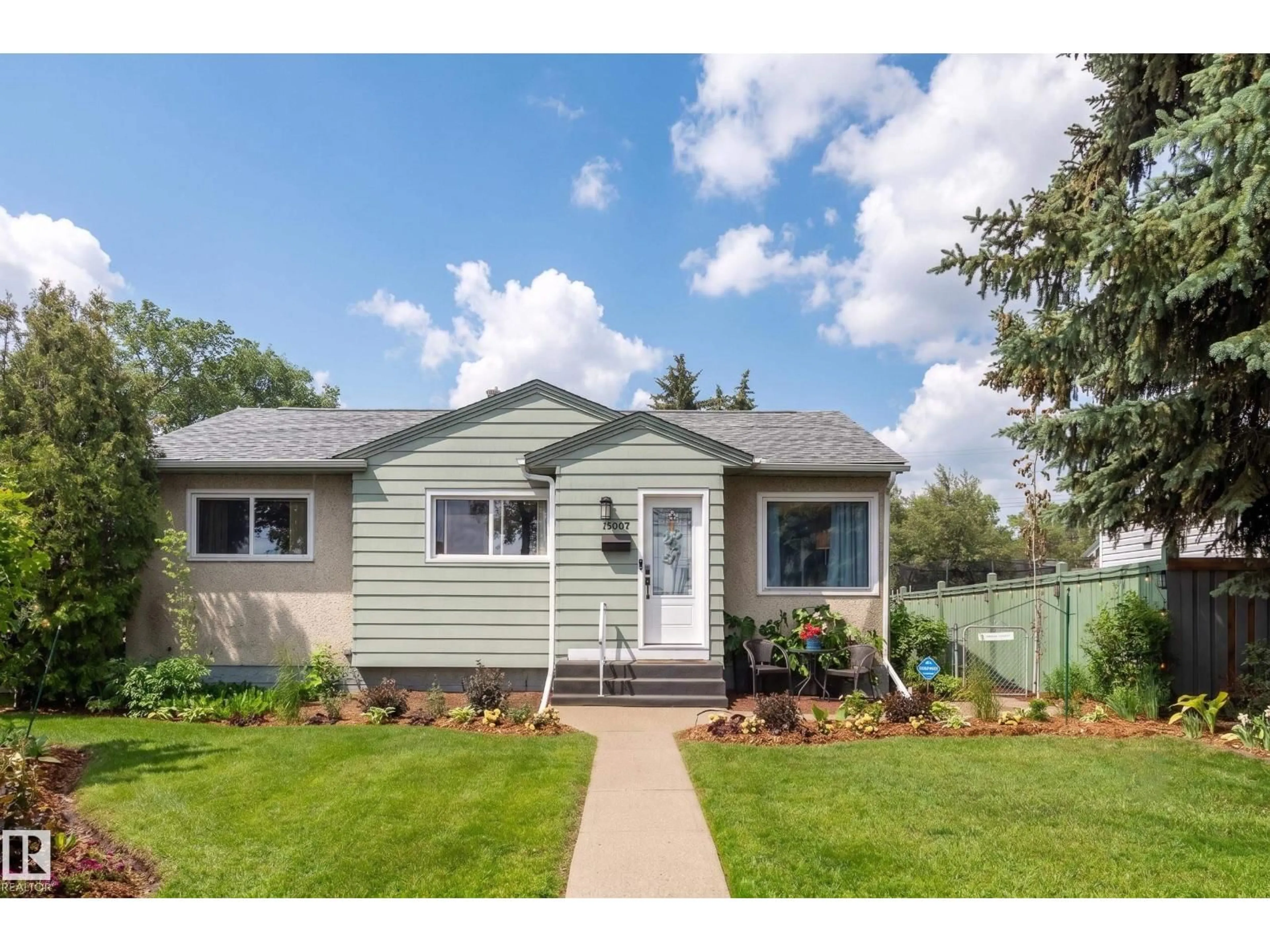 Home with vinyl exterior material, street for 13007 124 AV, Edmonton Alberta T5L2Z7