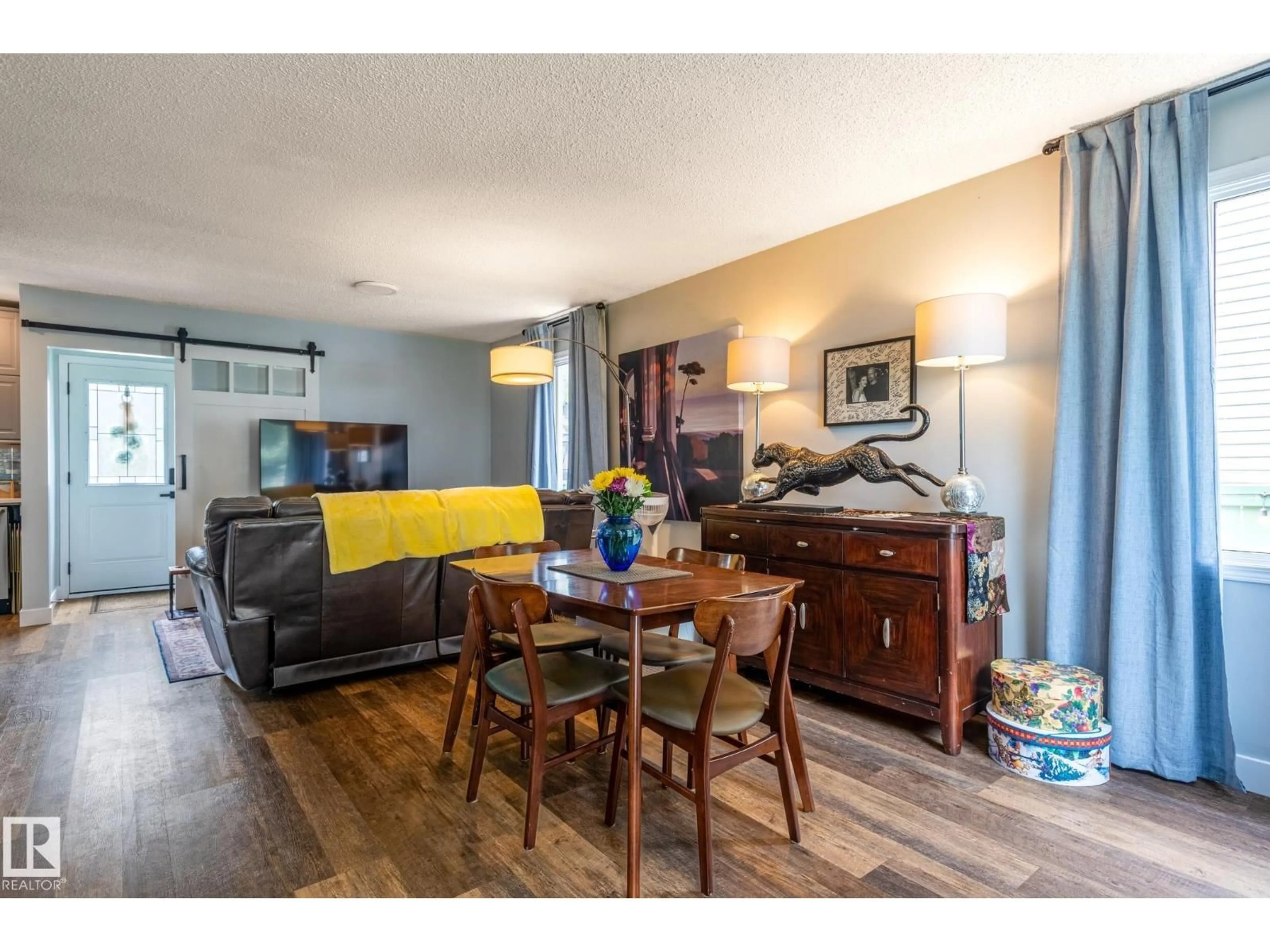 Living room with furniture, wood/laminate floor for 13007 124 AV, Edmonton Alberta T5L2Z7