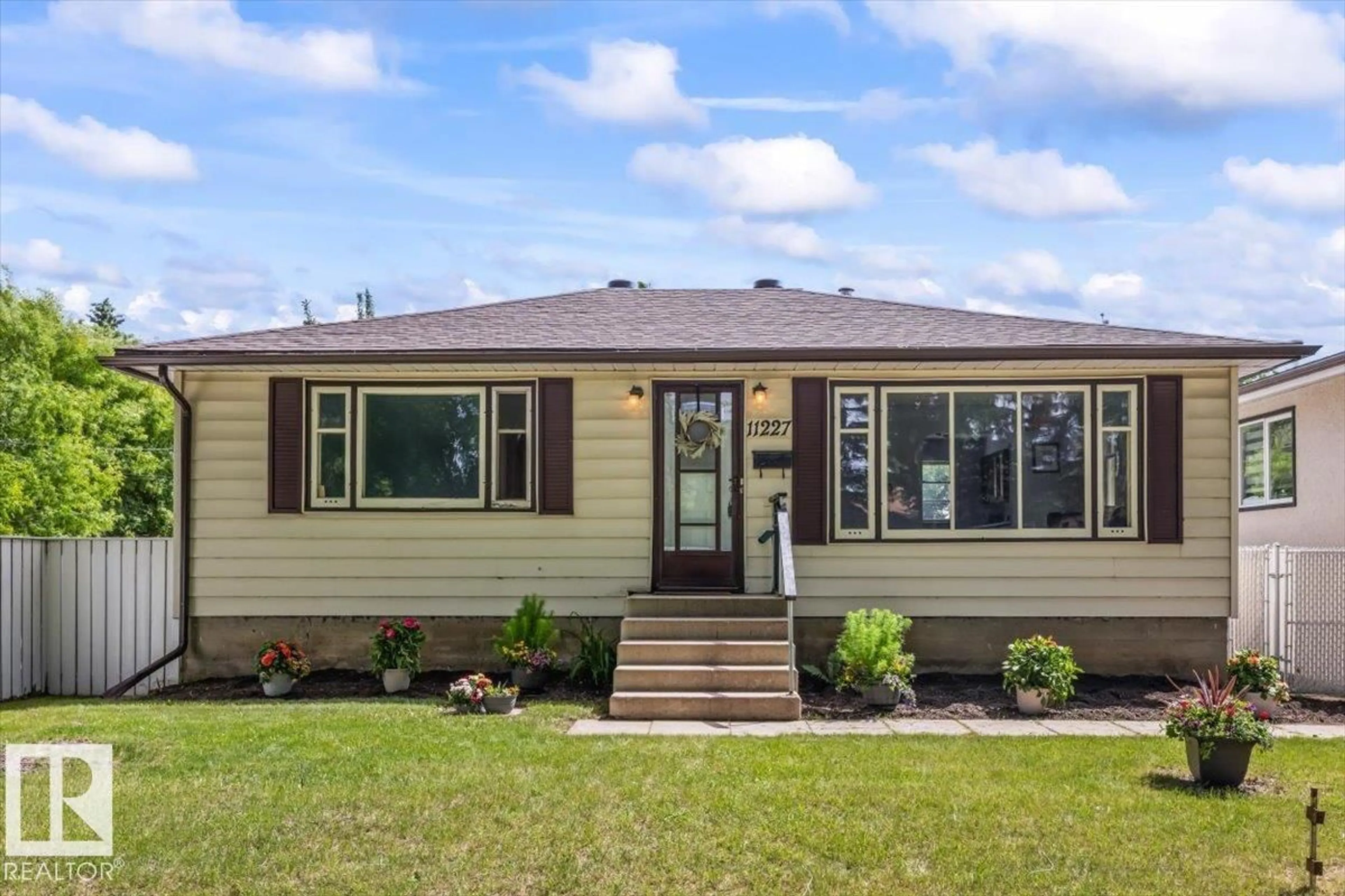 Home with vinyl exterior material, street for NW - 11227 52 ST, Edmonton Alberta T5W3H8