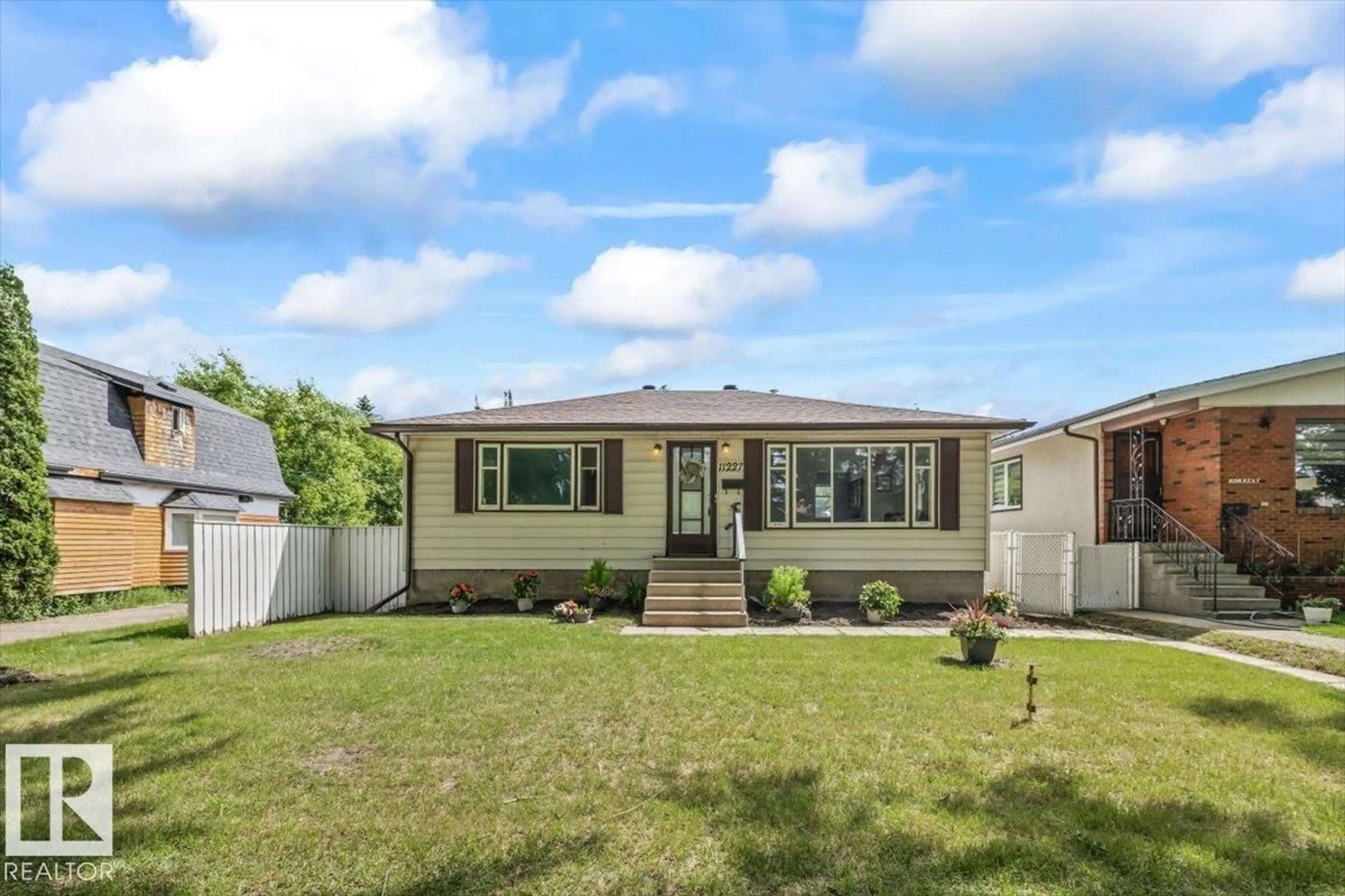 Home with vinyl exterior material, street for NW - 11227 52 ST, Edmonton Alberta T5W3H8