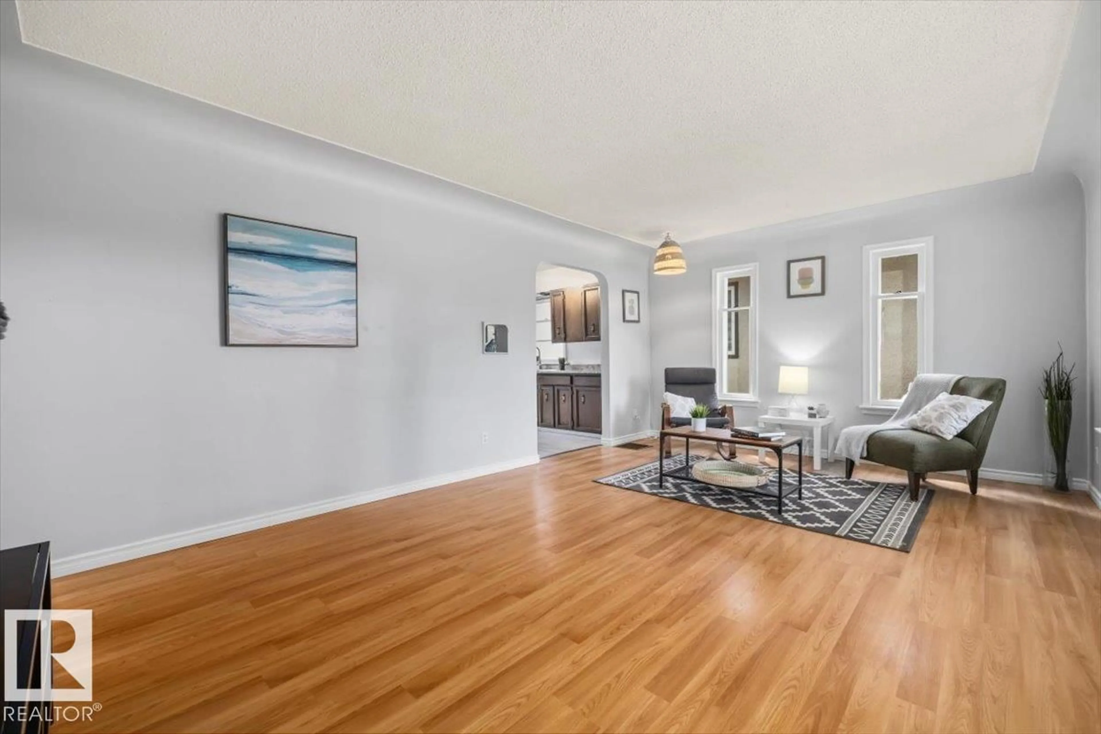 Living room with furniture, wood/laminate floor for NW - 11227 52 ST, Edmonton Alberta T5W3H8