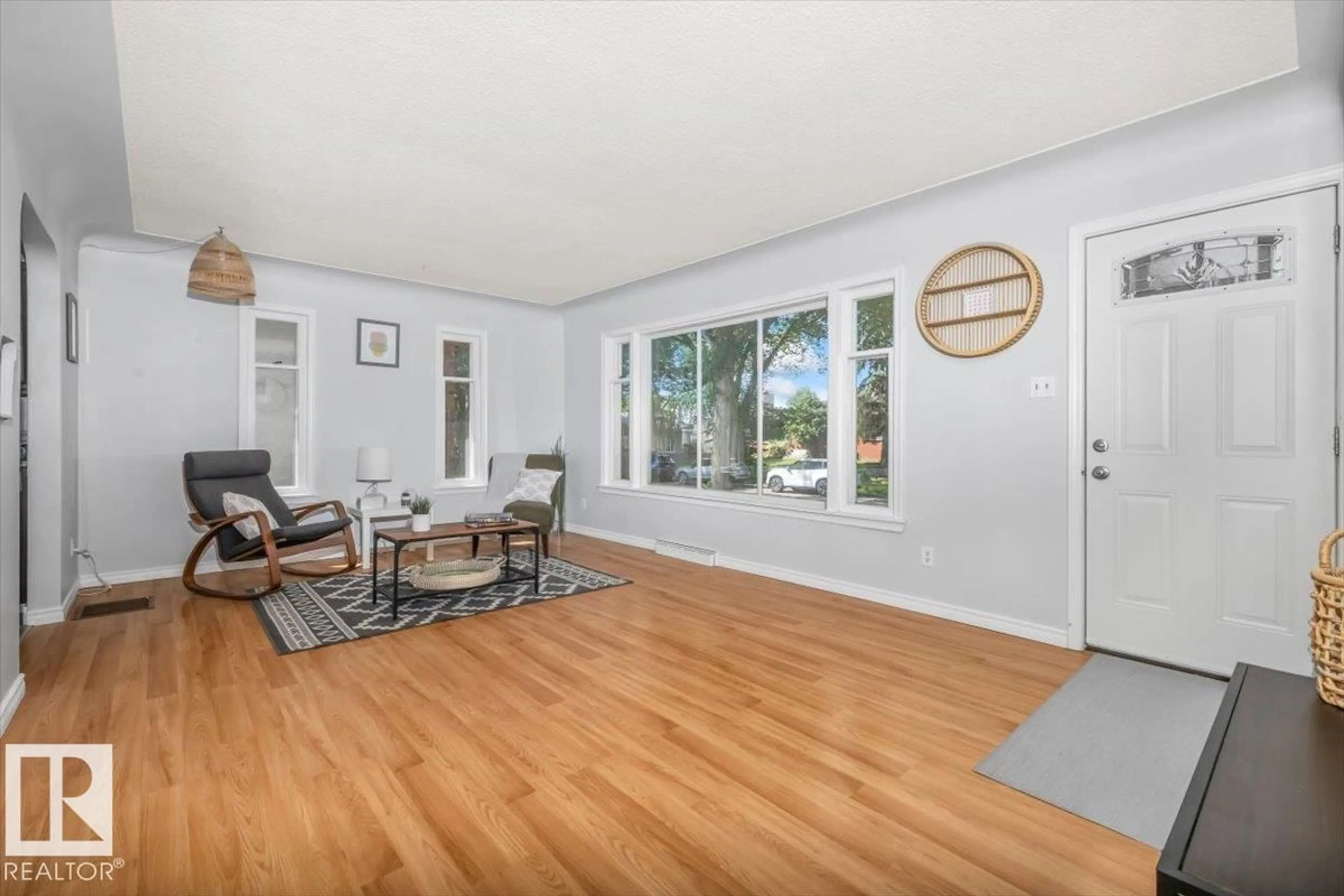 Living room with furniture, wood/laminate floor for NW - 11227 52 ST, Edmonton Alberta T5W3H8