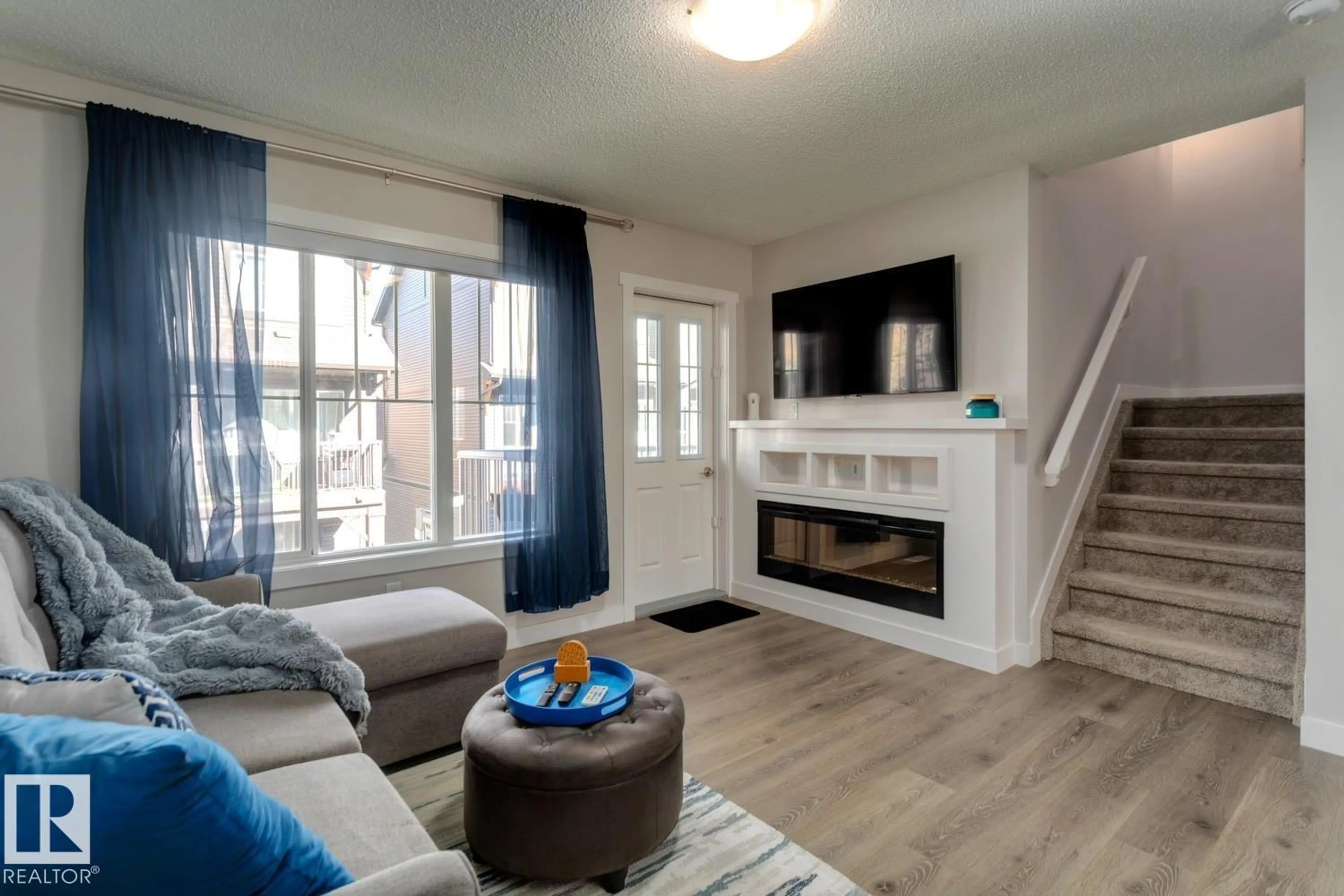 Living room with furniture, wood/laminate floor for 72 - 1005 GRAYDON HILL BV, Edmonton Alberta T6W3J5