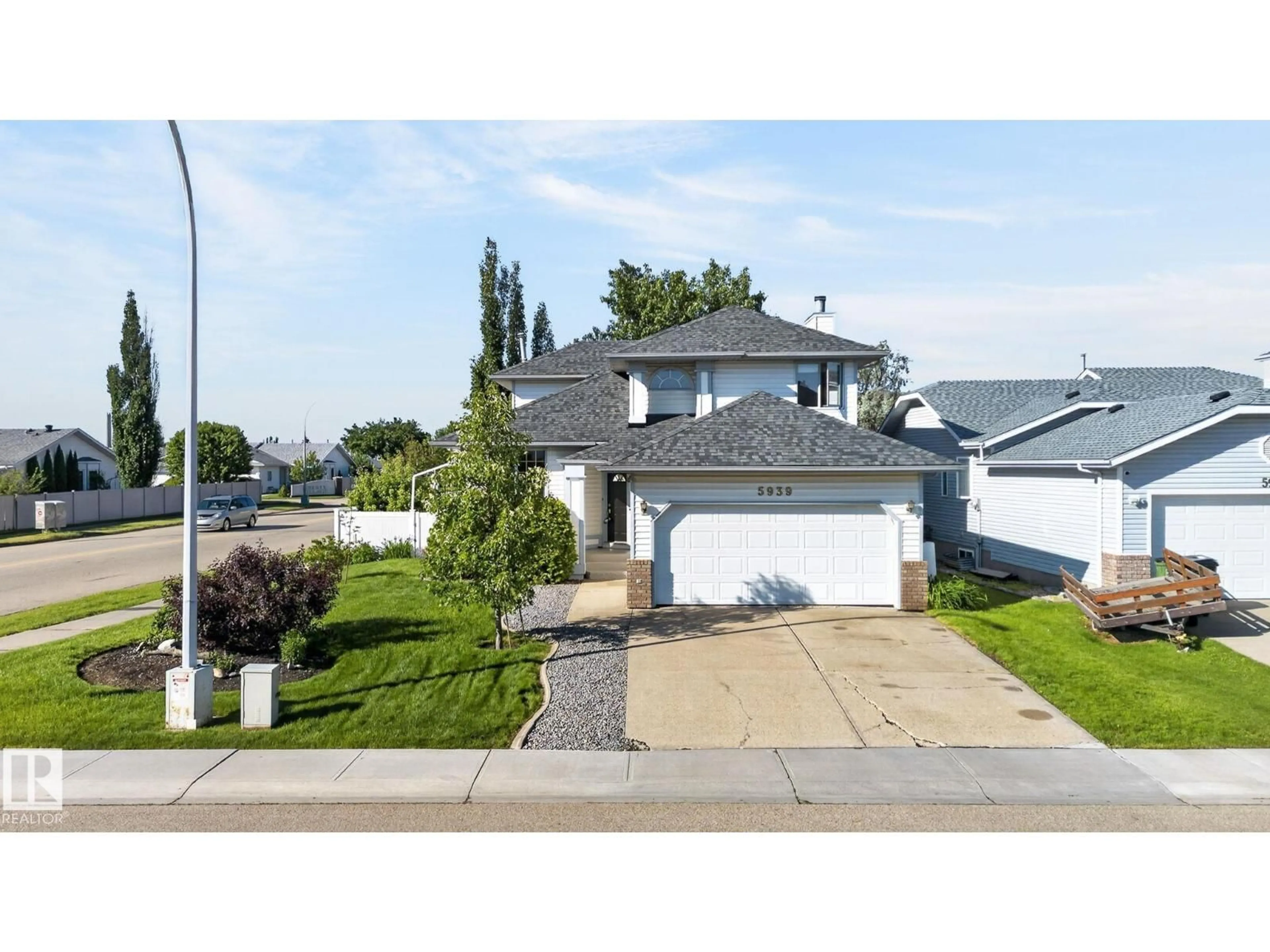 Home with vinyl exterior material, street for 5939 157 AV, Edmonton Alberta T5Y2M8