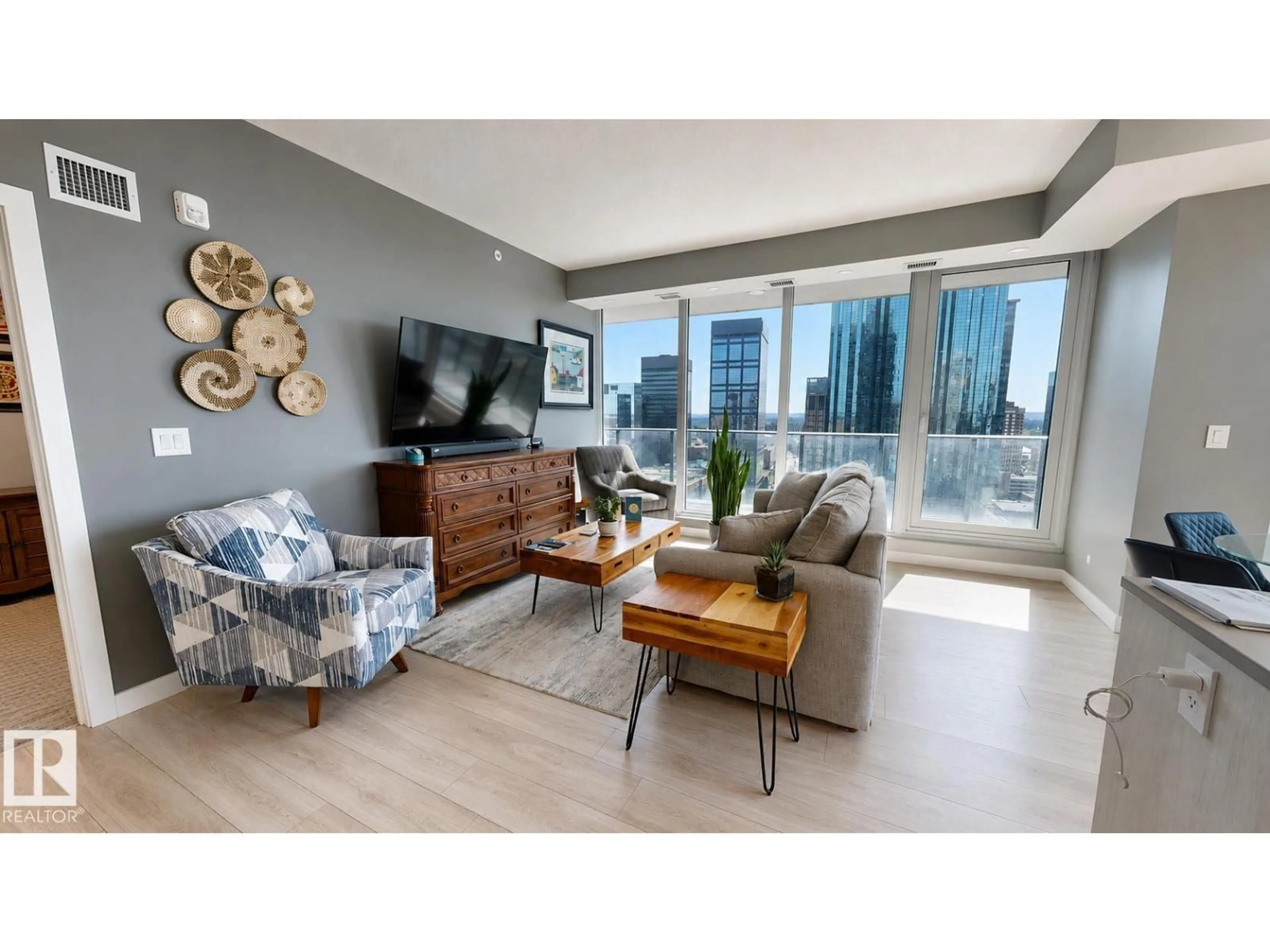 Living room with furniture, wood/laminate floor for 1904 - 10180 103 ST NW, Edmonton Alberta T5J0L1