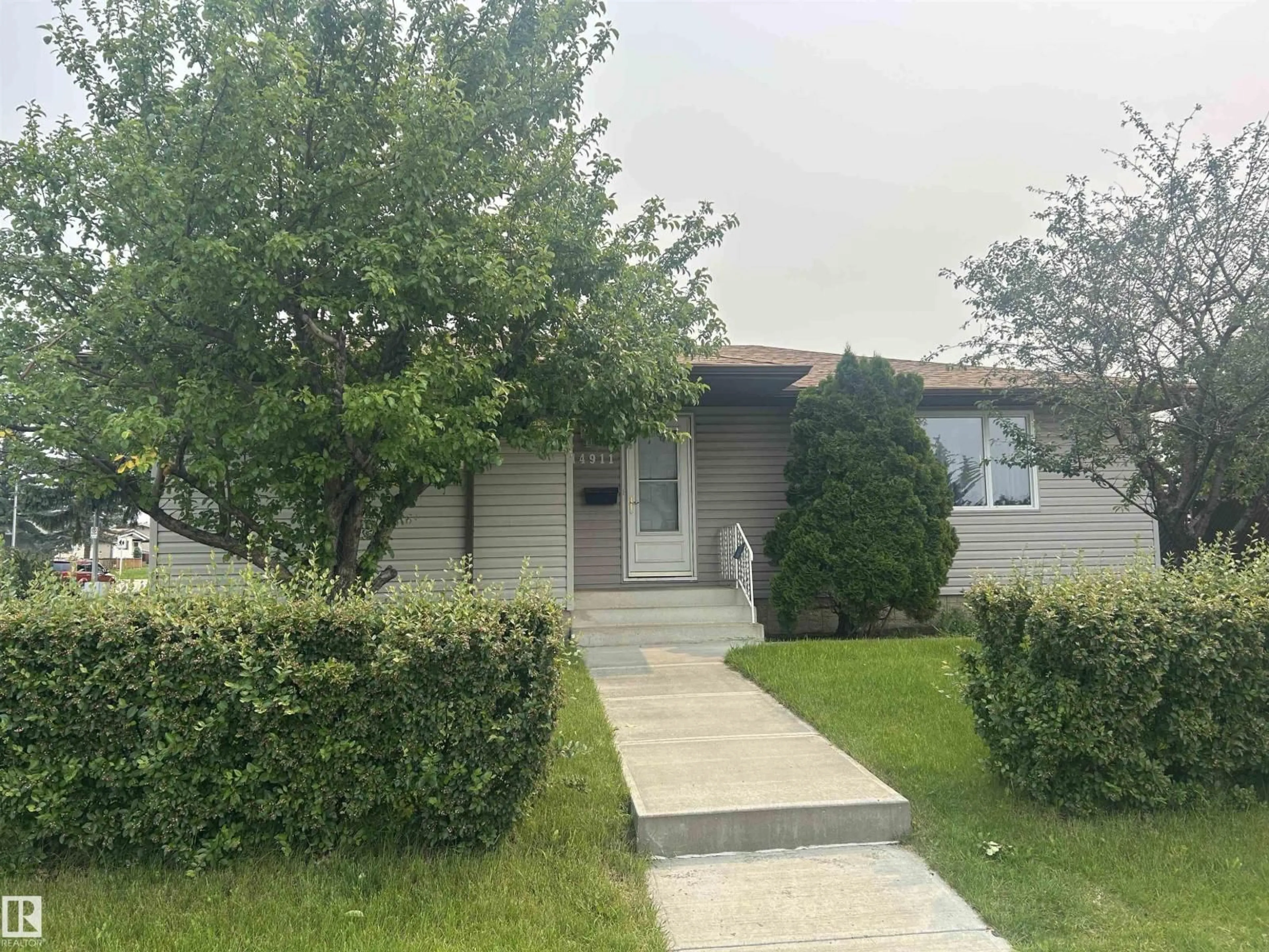 Home with vinyl exterior material, street for 14911 77 ST, Edmonton Alberta T5C1E9