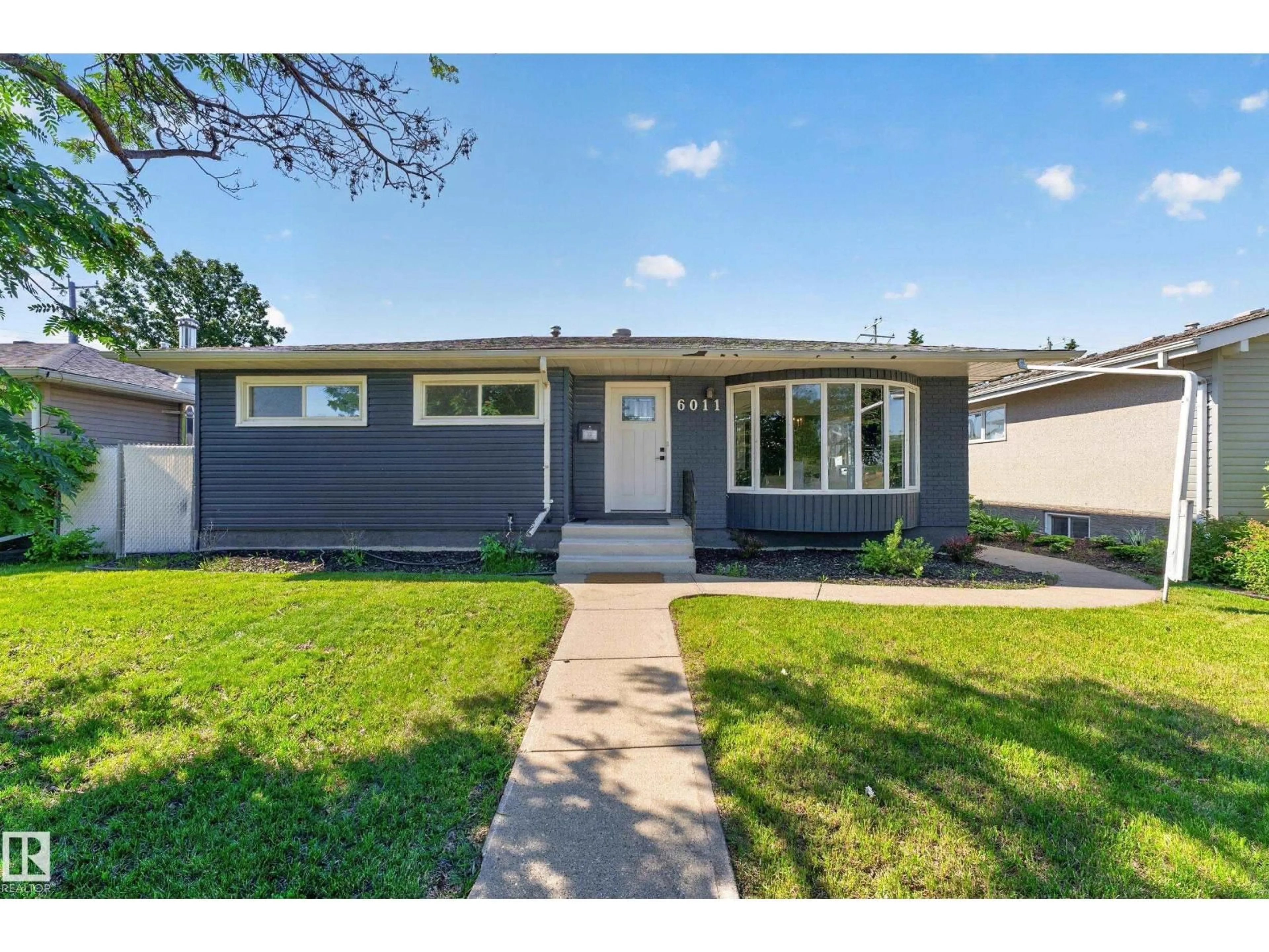 Home with vinyl exterior material, street for 6011 93A AV, Edmonton Alberta T6B0X1