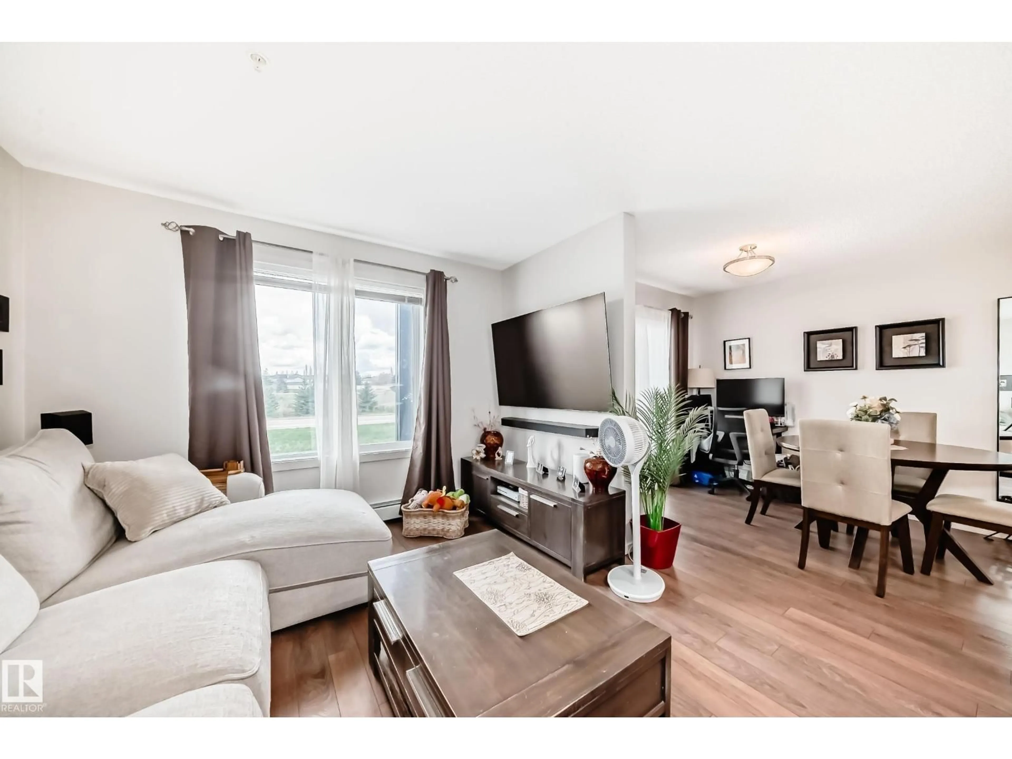 Living room with furniture, wood/laminate floor for 142 - 311 EBBERS BV, Edmonton Alberta T5Y3W2