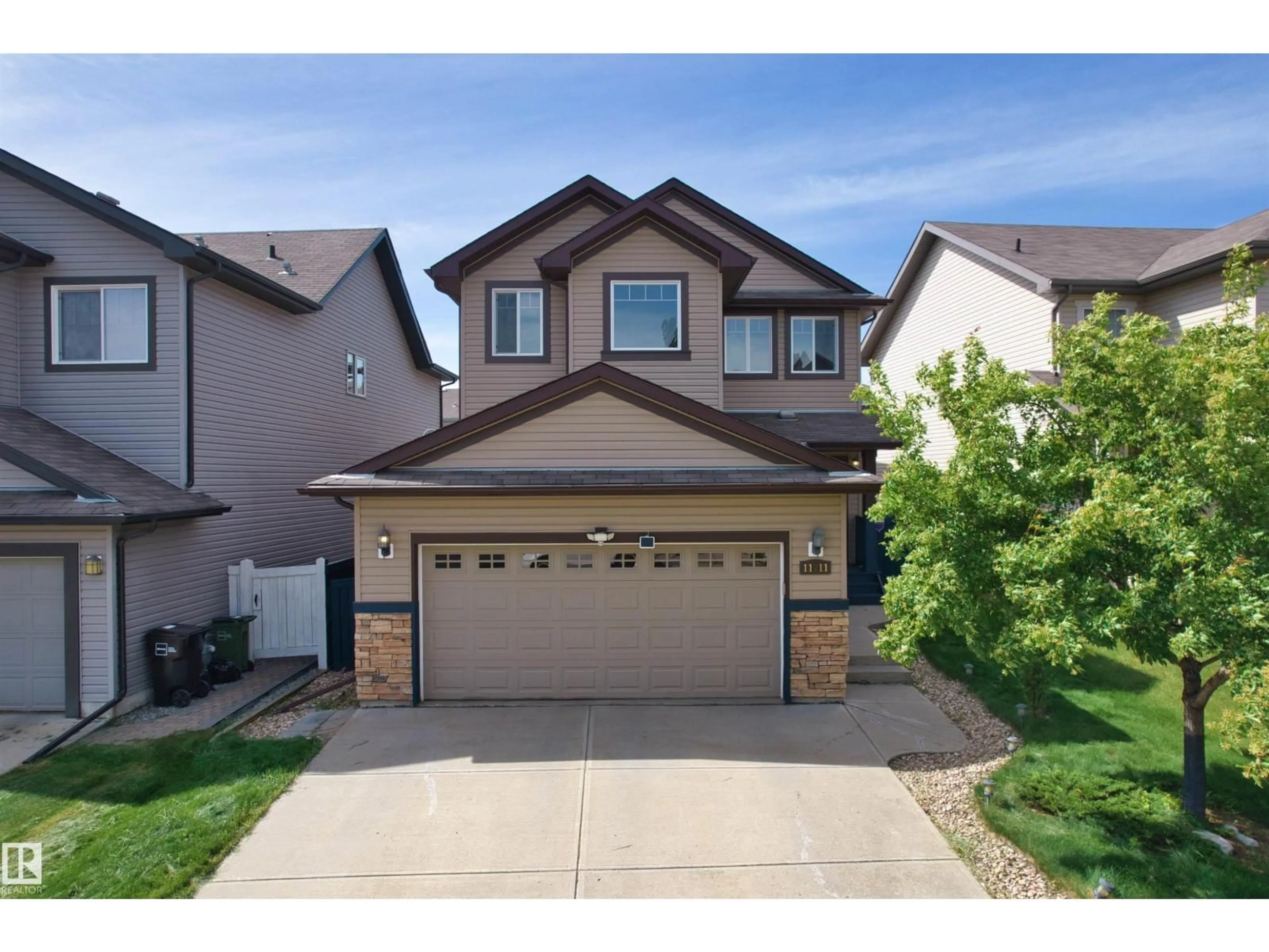 Home with vinyl exterior material, street for 11711 16 AVE SW, Edmonton Alberta T6W1M9
