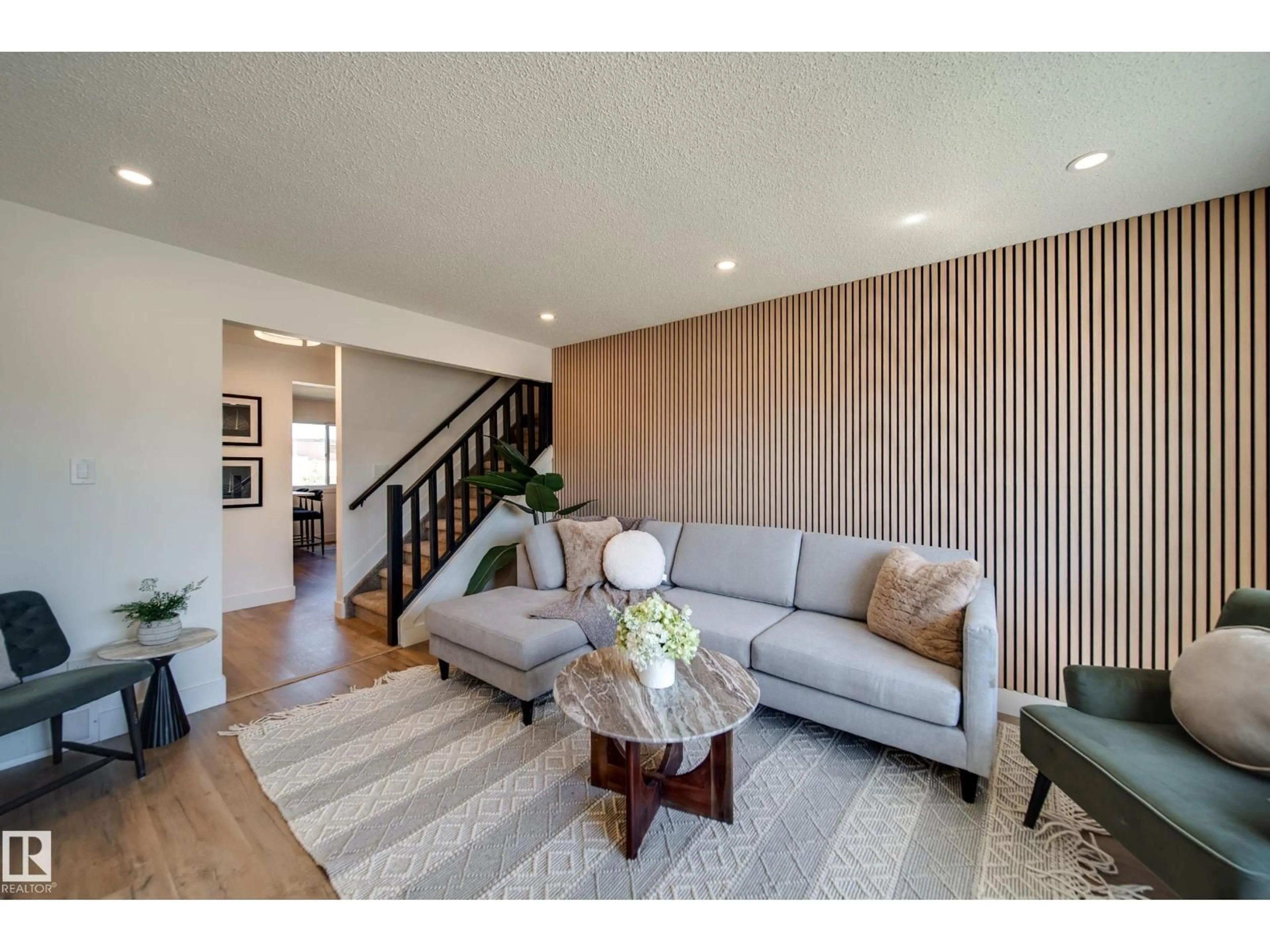 Living room with furniture, wood/laminate floor for 10343 172 AV, Edmonton Alberta T5X5C2
