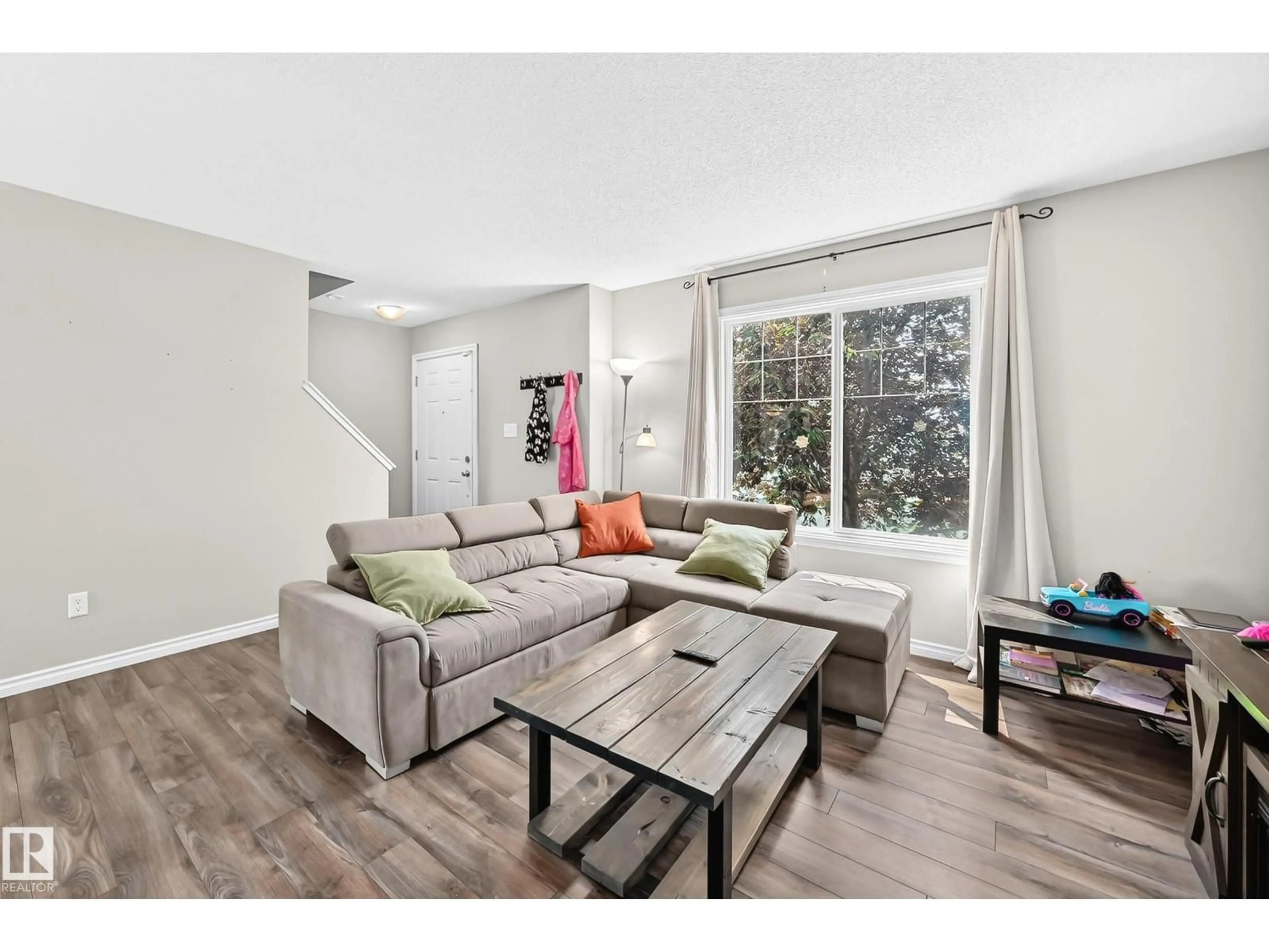 Living room with furniture, wood/laminate floor for 21 - 8716 179 AV, Edmonton Alberta T5Z0J3