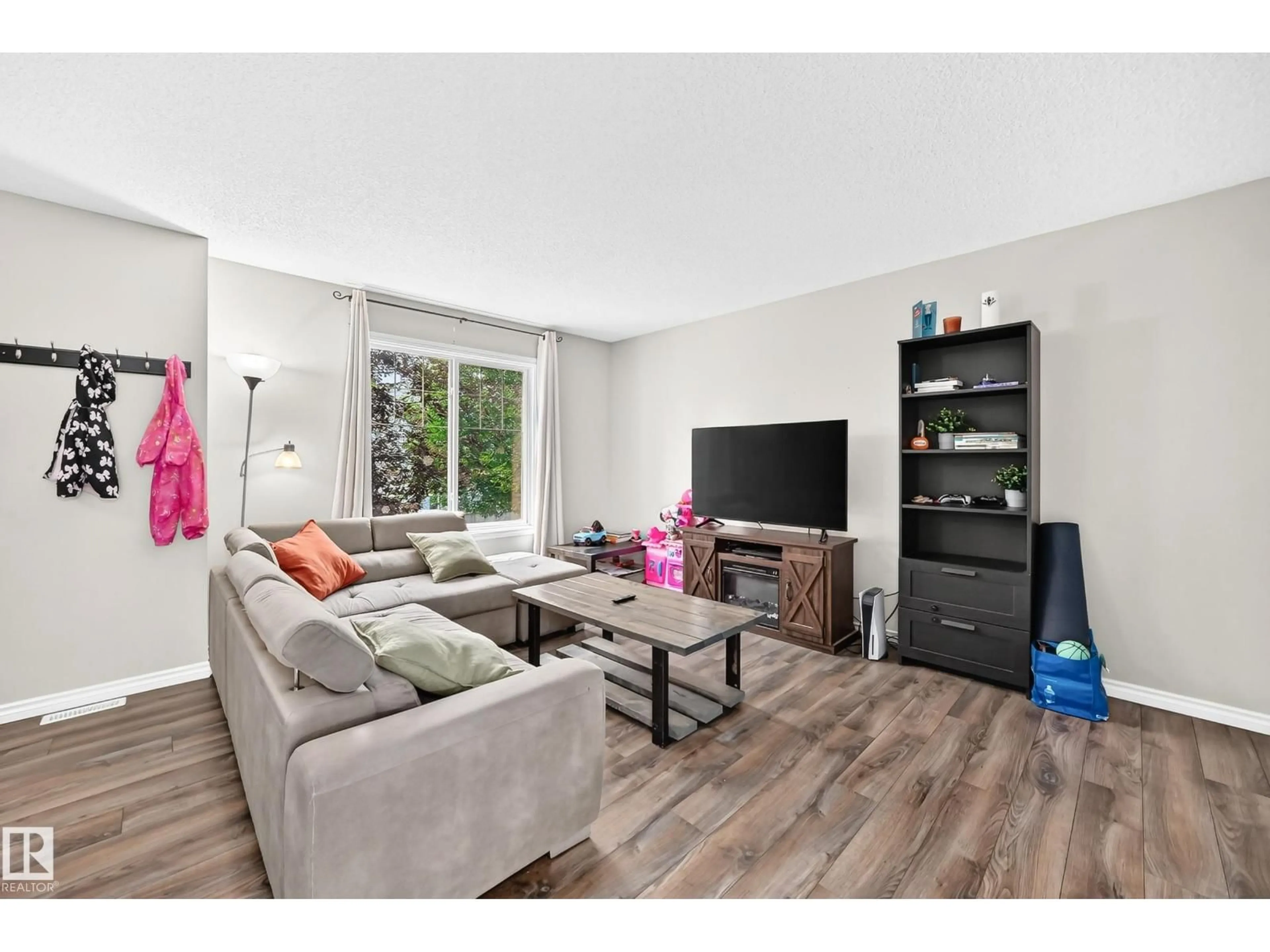Living room with furniture, wood/laminate floor for 21 - 8716 179 AV, Edmonton Alberta T5Z0J3