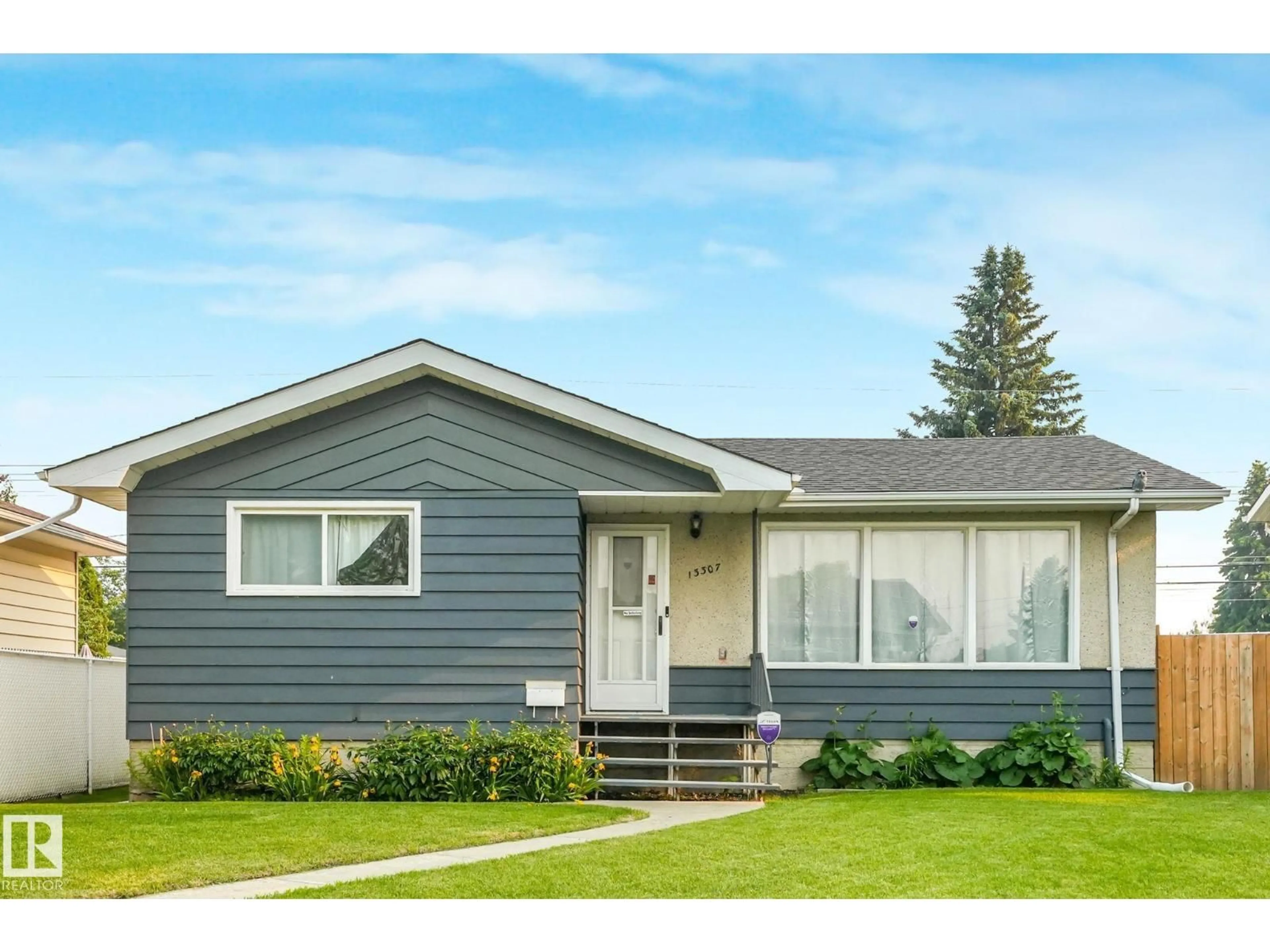 Home with vinyl exterior material, street for 13307 133 AV NW, Edmonton Alberta T5L3S8