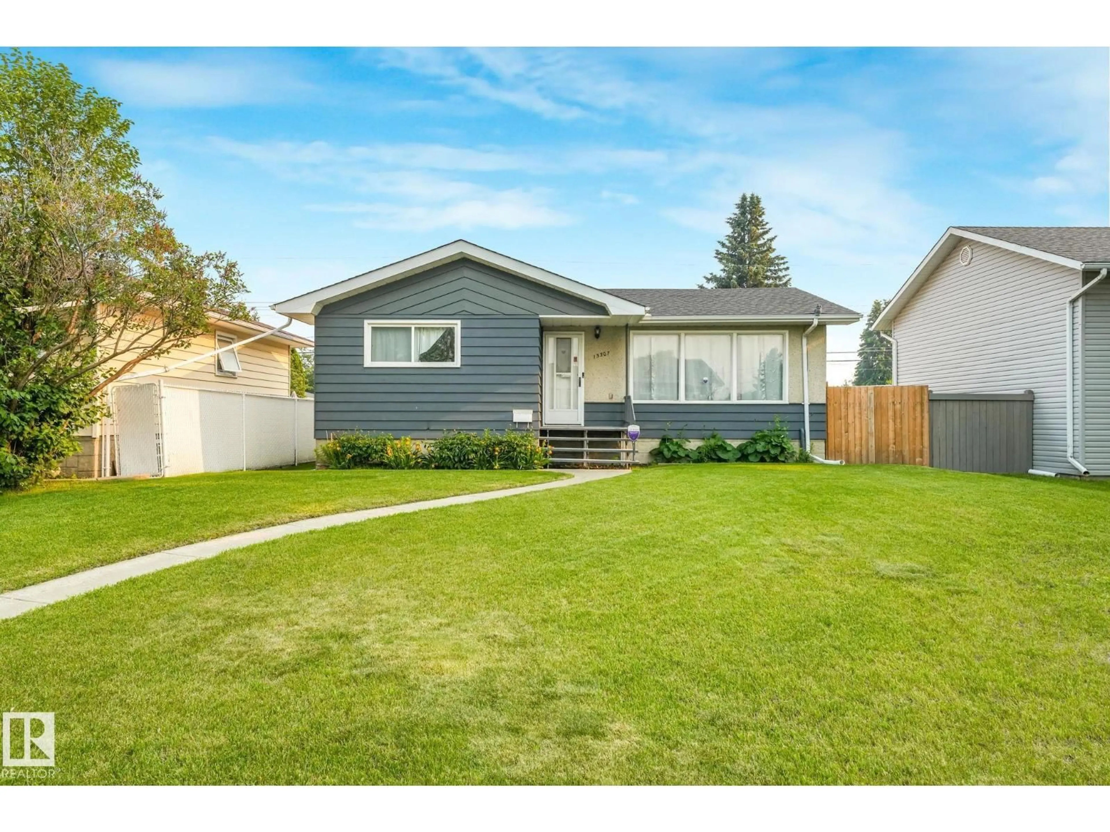 Home with vinyl exterior material, street for 13307 133 AV NW, Edmonton Alberta T5L3S8