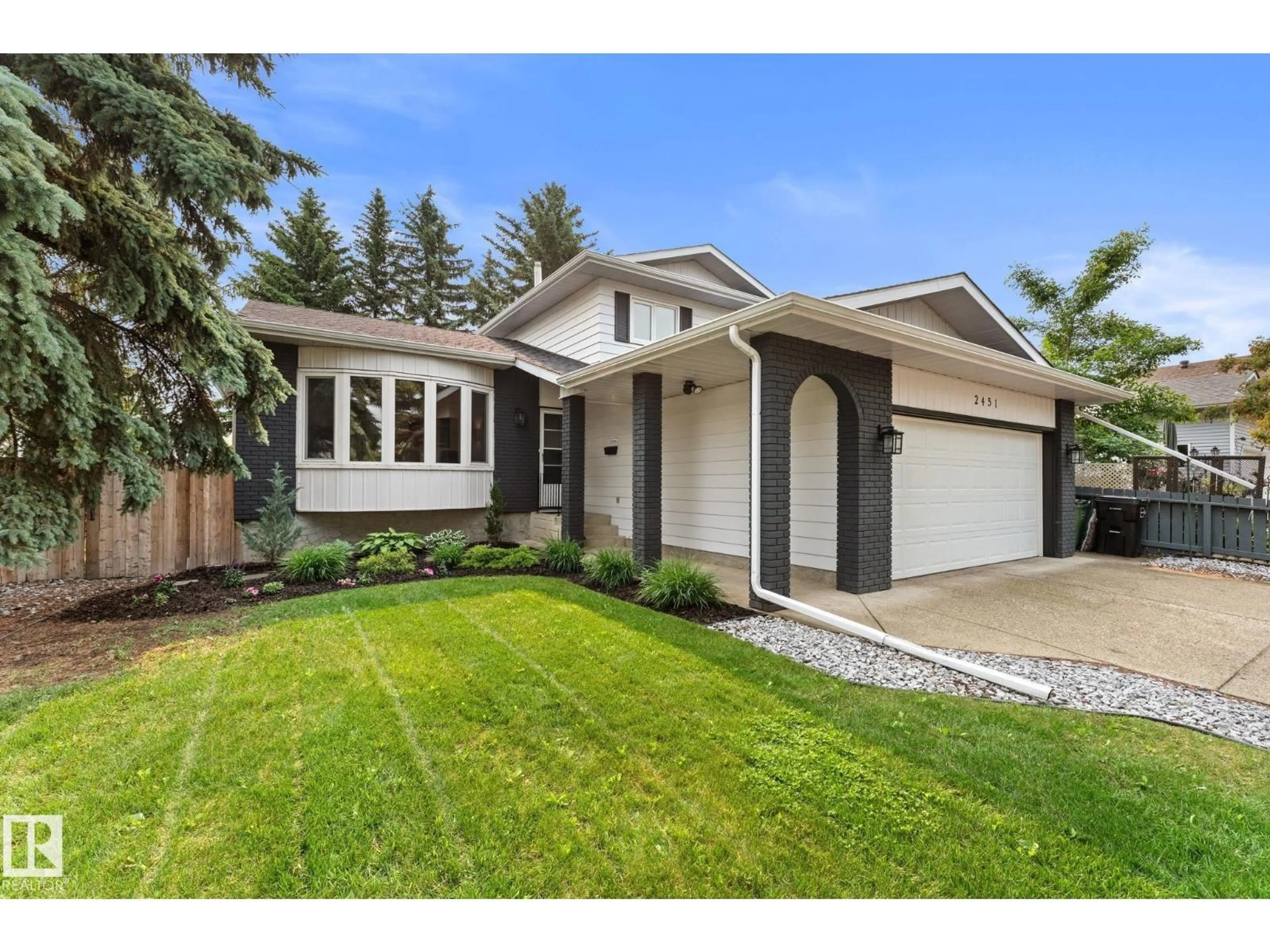 Home with vinyl exterior material, street for NW - 2451 115 ST, Edmonton Alberta T6J4Z2