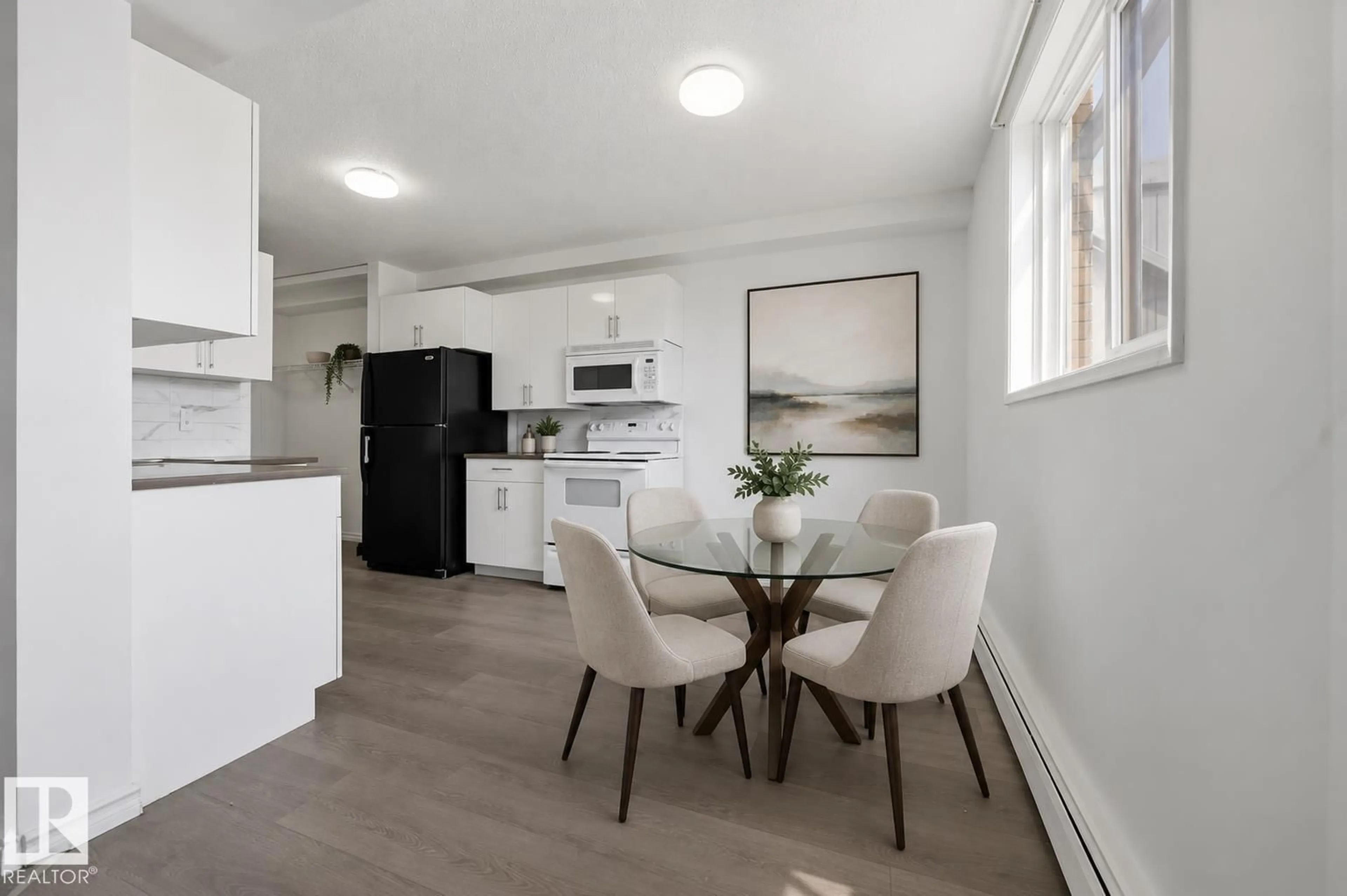 Open concept kitchen, wood/laminate floor for 105 - 14530 52 ST, Edmonton Alberta T5A3K5