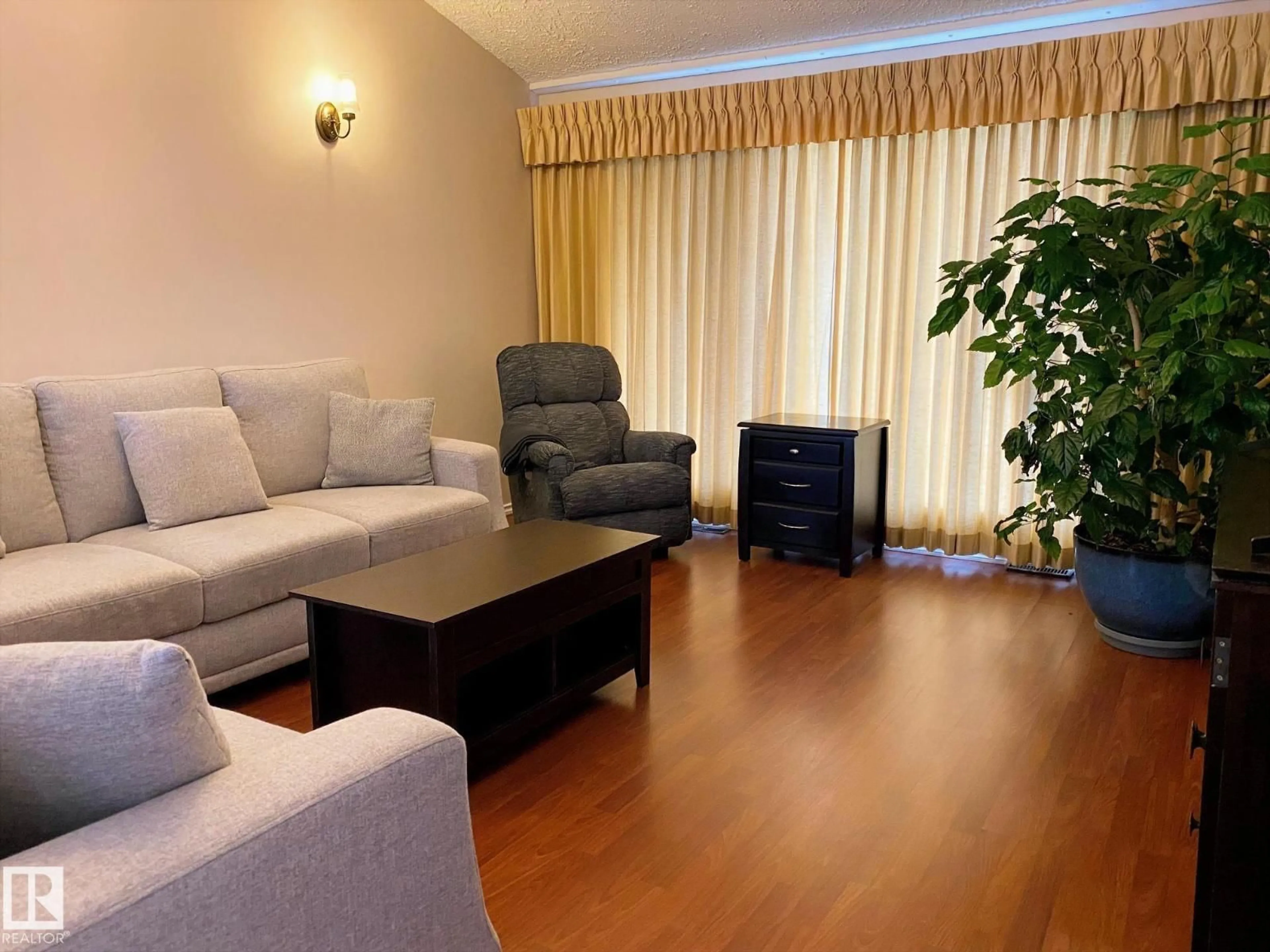 Living room with furniture, wood/laminate floor for 2211 MILLBOURNE RD W, Edmonton Alberta T6K0Y3