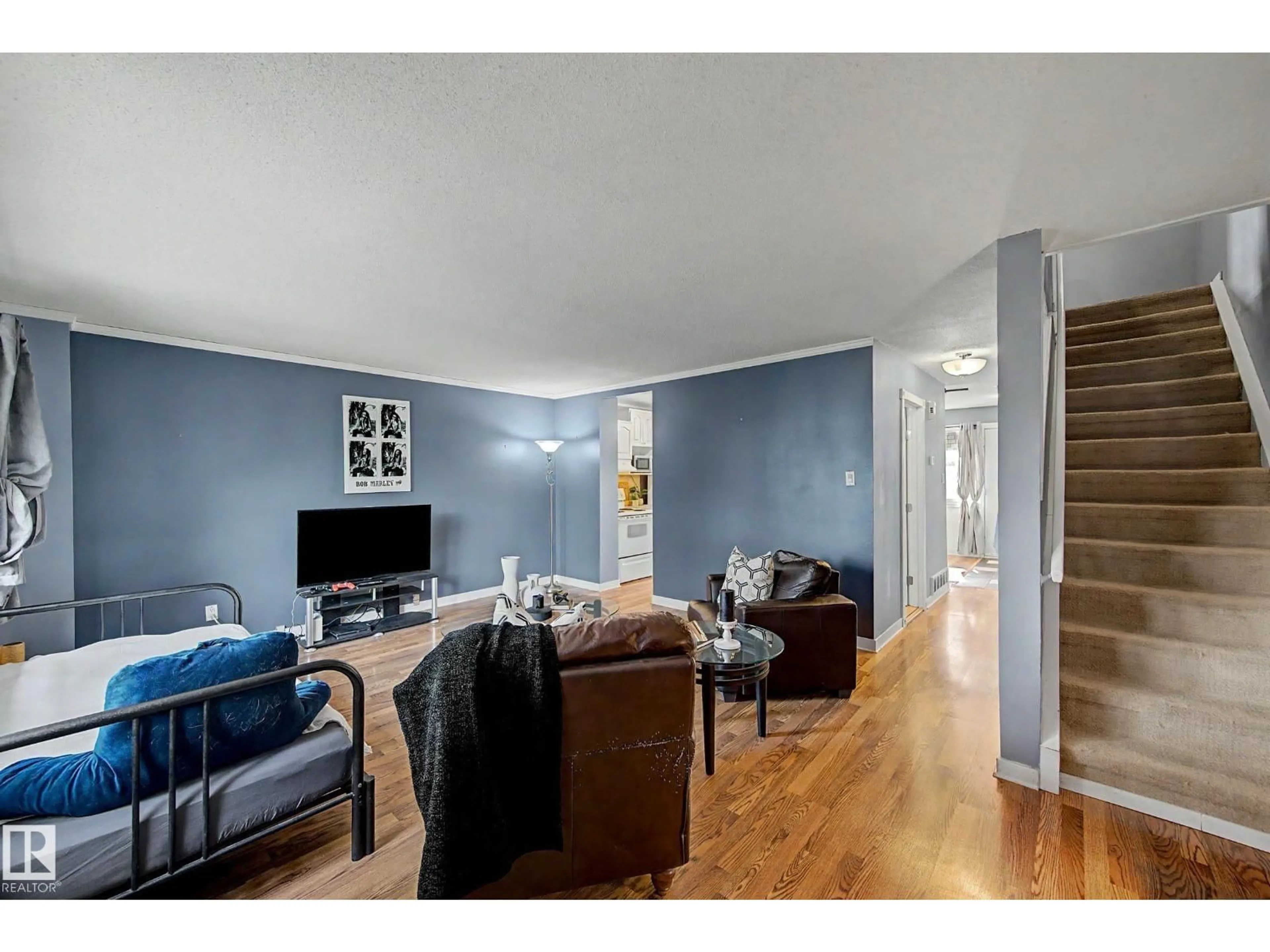 Living room with furniture, wood/laminate floor for NW - 219 VILLAGE ON THE GREEN GR, Edmonton Alberta T5A1H2