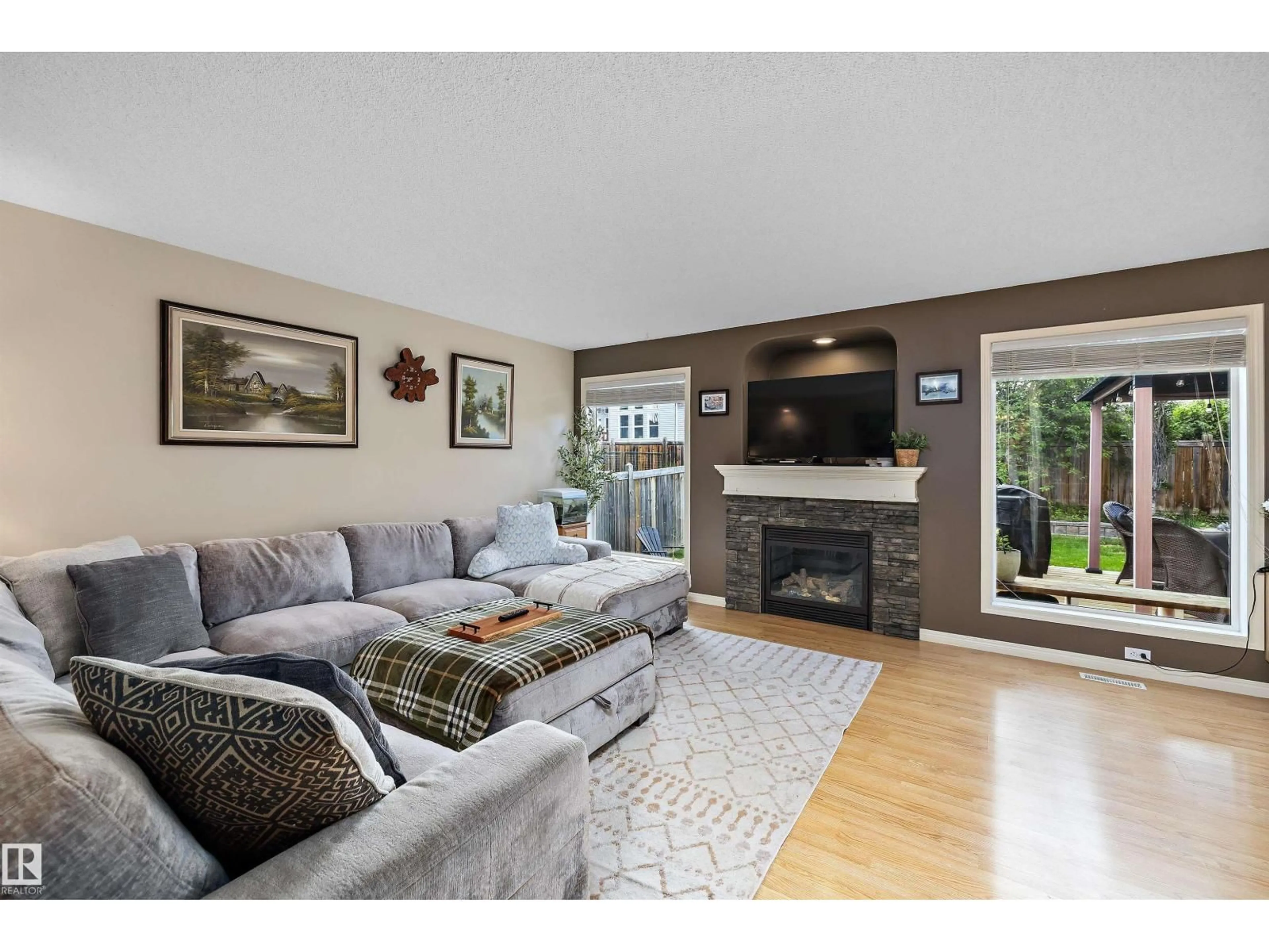 Living room with furniture, wood/laminate floor for 33 LAMPLIGHT DR, Spruce Grove Alberta T7X4N1
