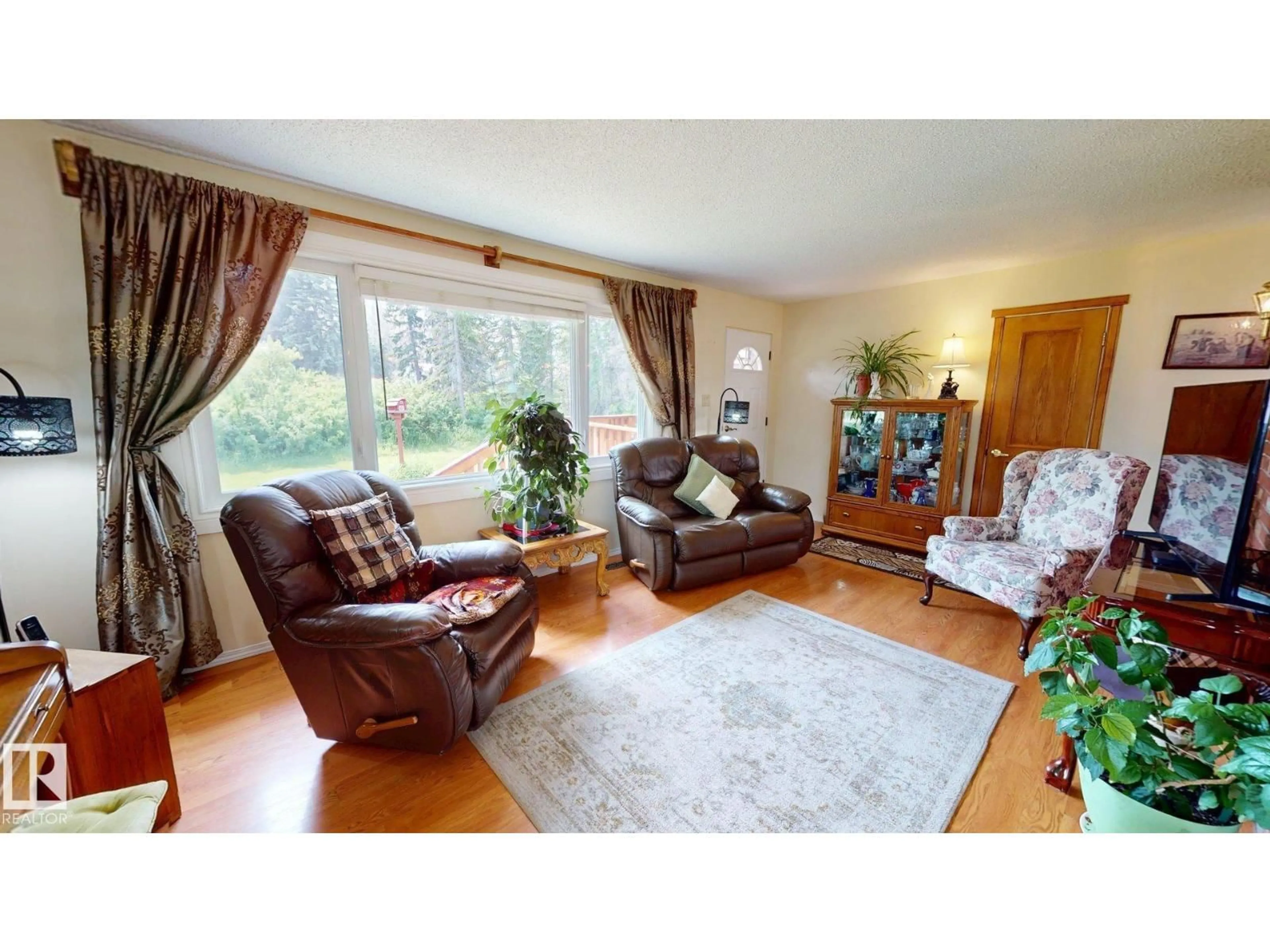 Living room with furniture, wood/laminate floor for 5004 50 AV, Evansburg Alberta T0E0T0