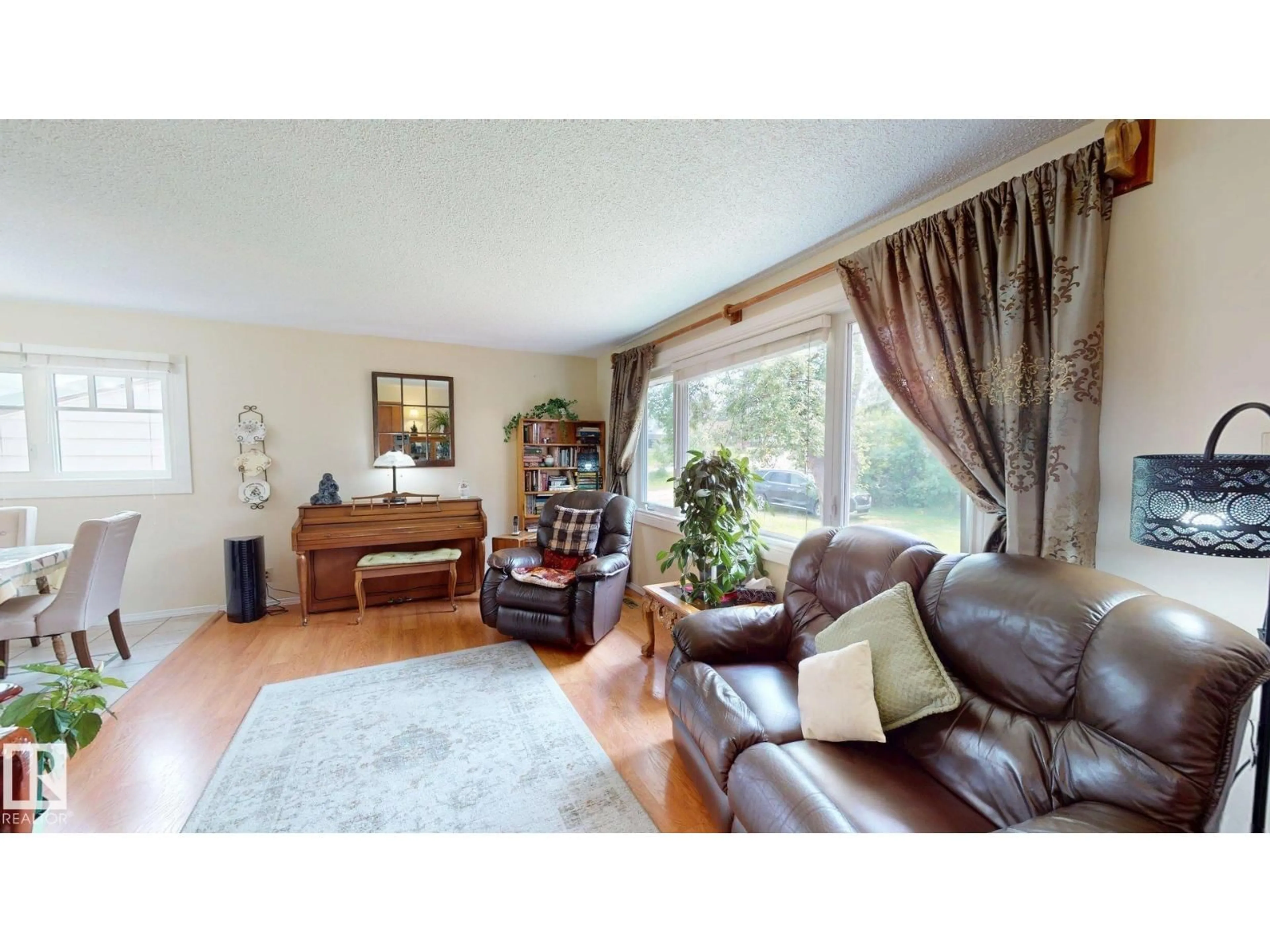 Living room with furniture, wood/laminate floor for 5004 50 AV, Evansburg Alberta T0E0T0